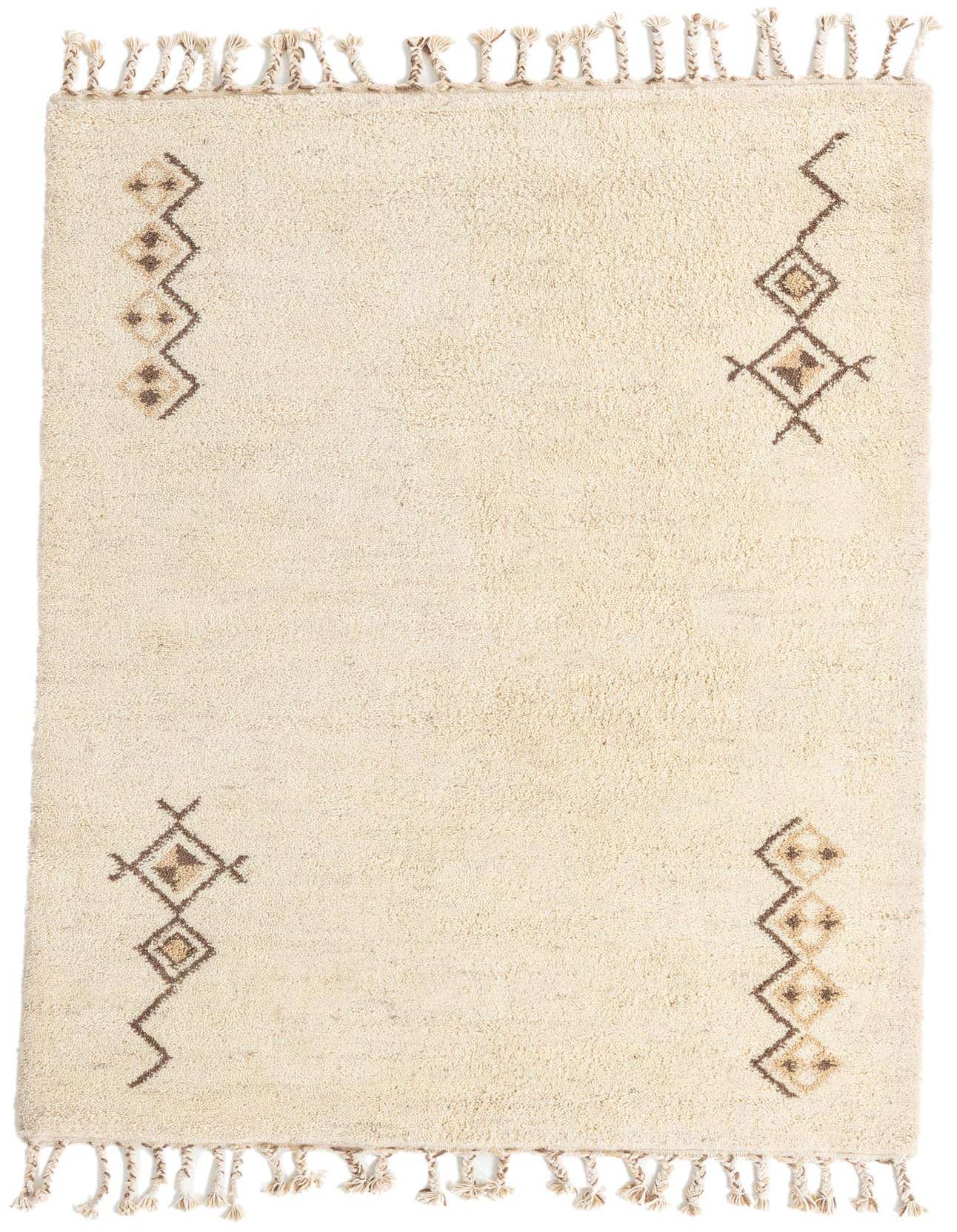 A 6x9 rectangular ivory shag rug with brown tribal geometric patterns and braided tassels on a white background.