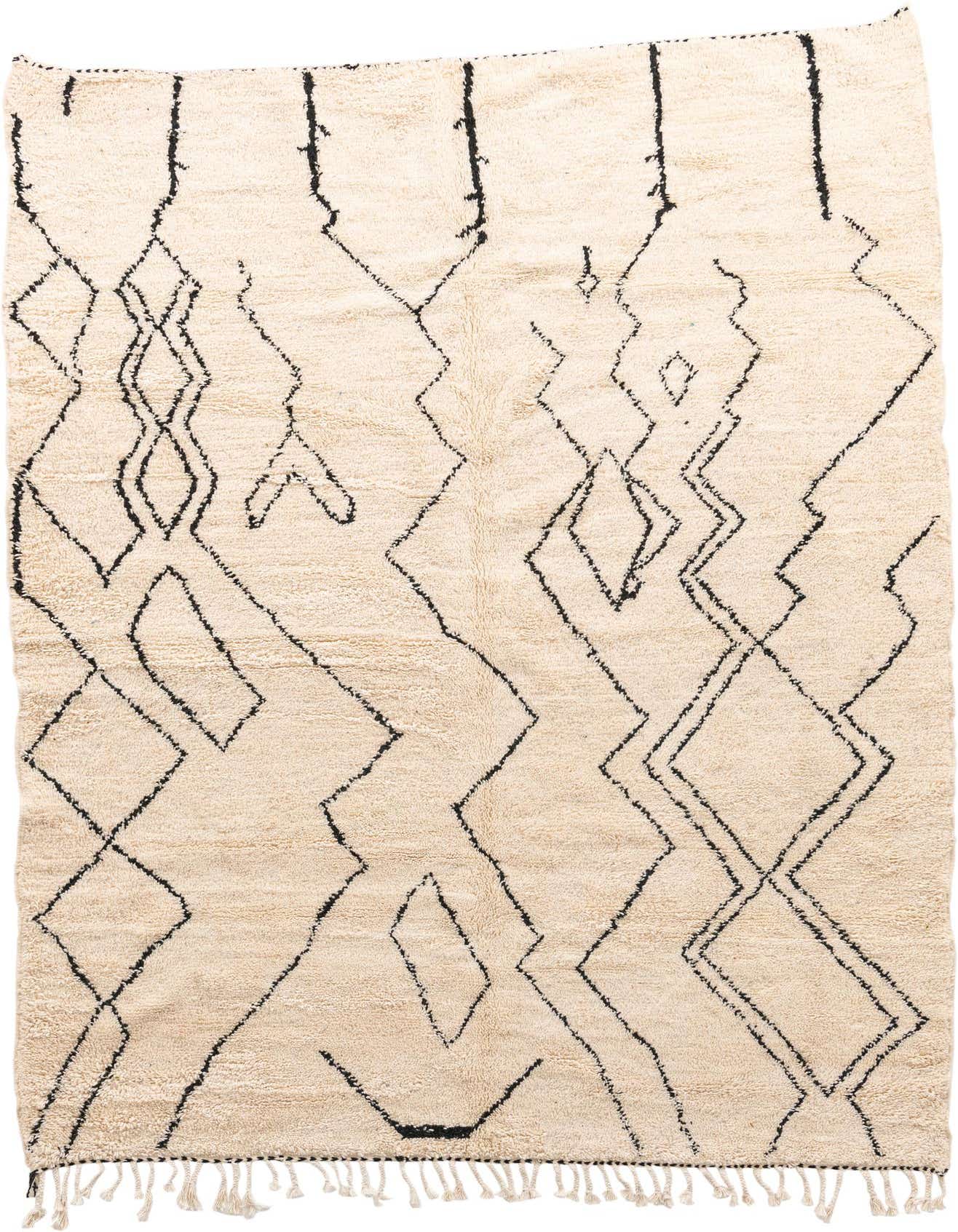 A 7x10 rectangular ivory shag rug with a modern tribal abstract pattern in black, featuring tassels along one edge.