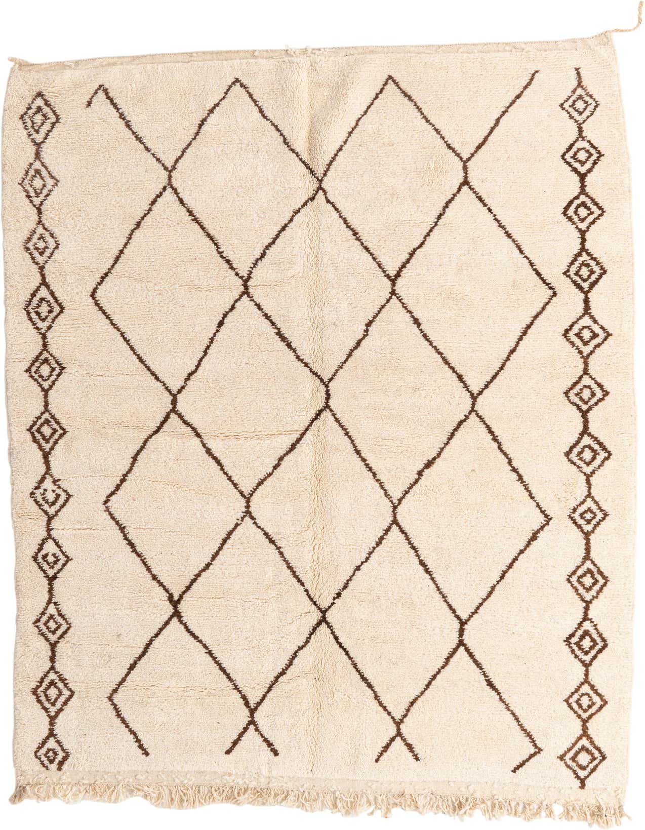A 7x10 rectangular ivory shag rug with a brown tribal diamond pattern and decorative border, suitable for a living room.