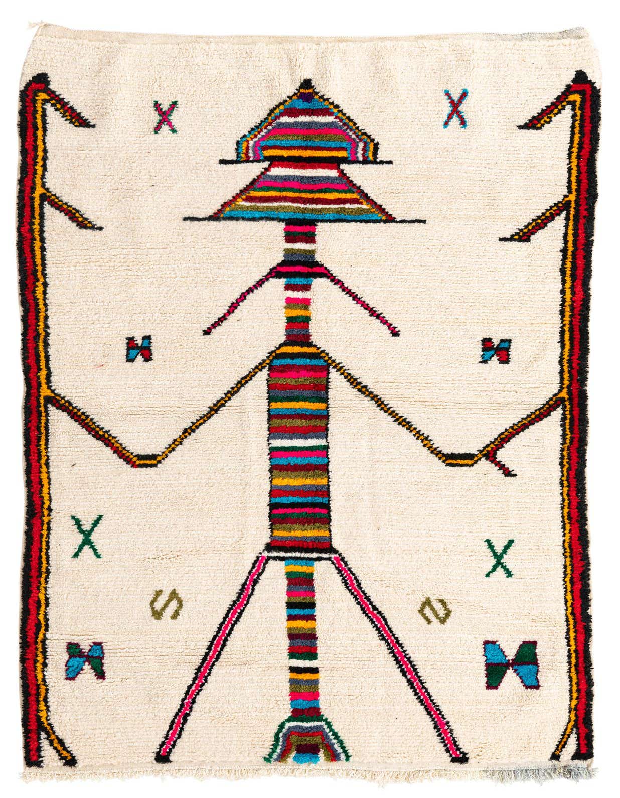 A 5x8 rectangular ivory shag rug with a vibrant, colorful tribal abstract design featuring a central figure and geometric patterns.