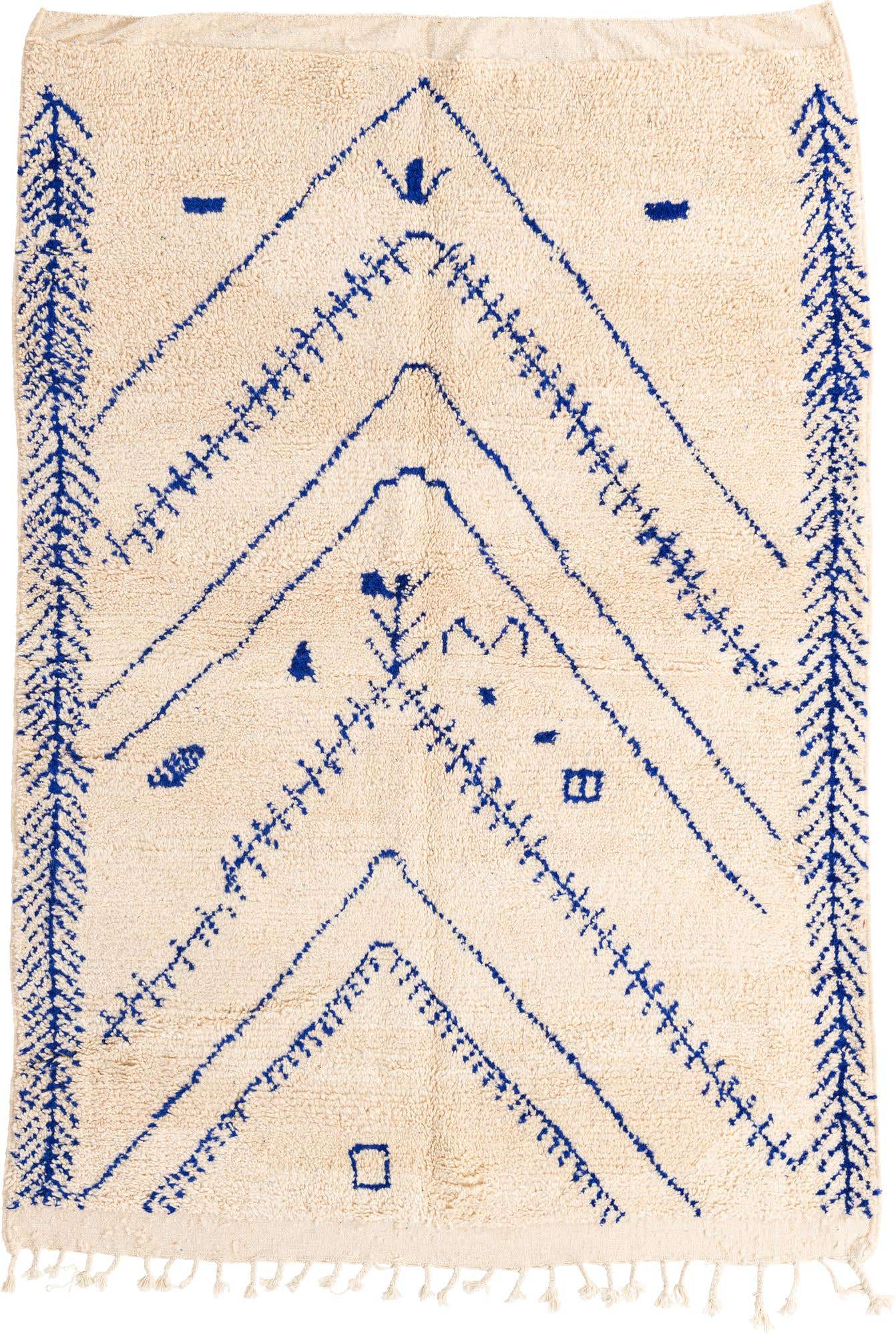 A 5x8 rectangular ivory shag rug with a modern tribal pattern in deep blue, featuring abstract geometric shapes and lines.