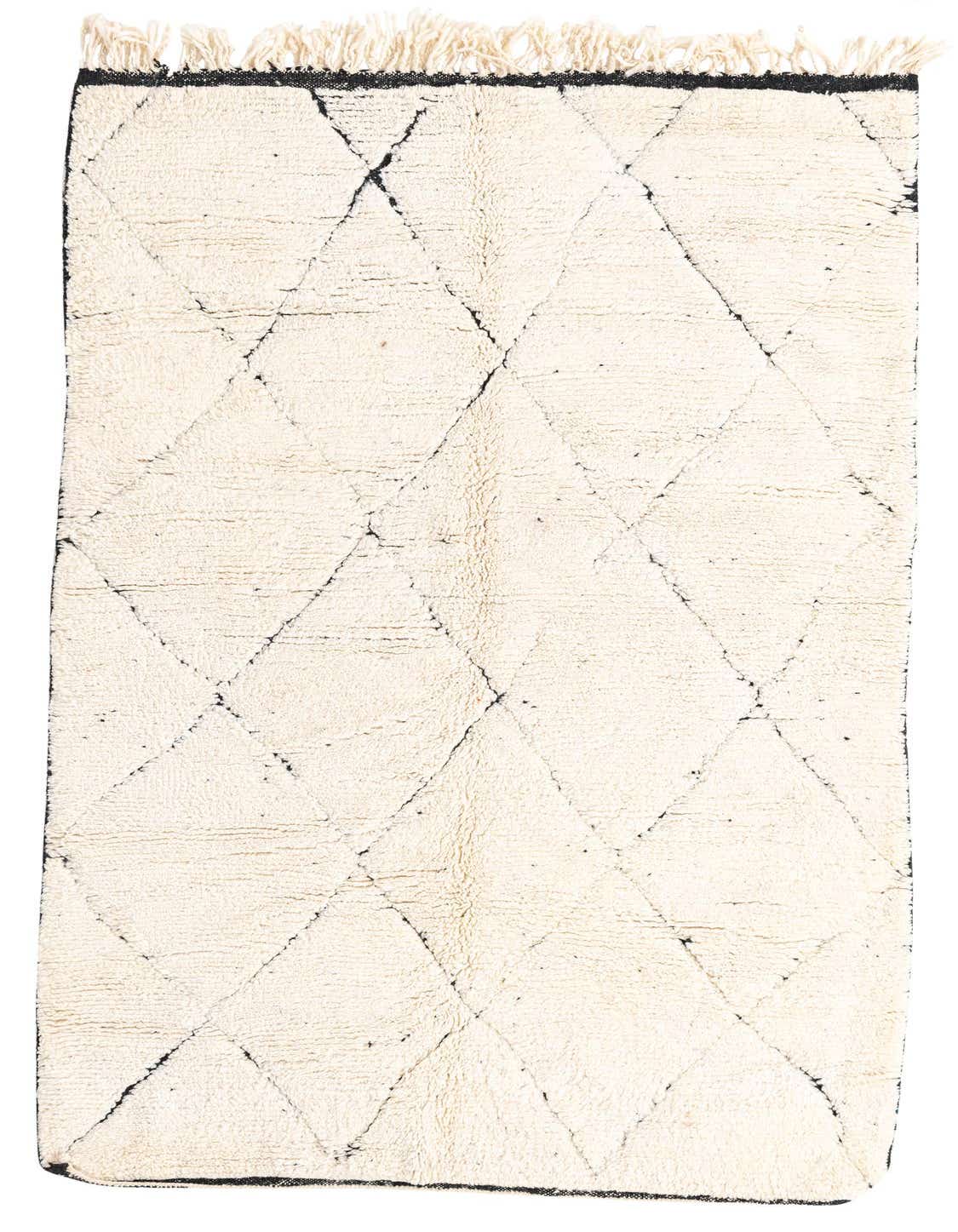 A 5x8 rectangular ivory shag rug with a black tribal diamond pattern and fringe, suitable for a living room.