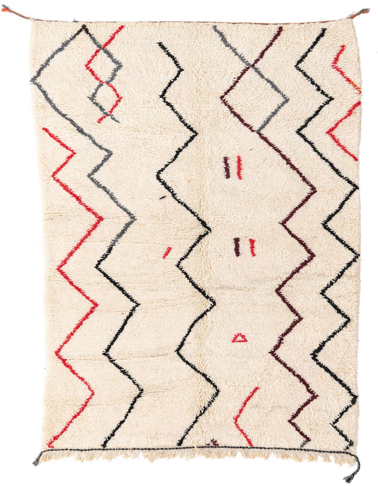 A rectangular 5x8 ivory shag rug with a modern tribal pattern of black, red, and gray zigzags and abstract shapes.