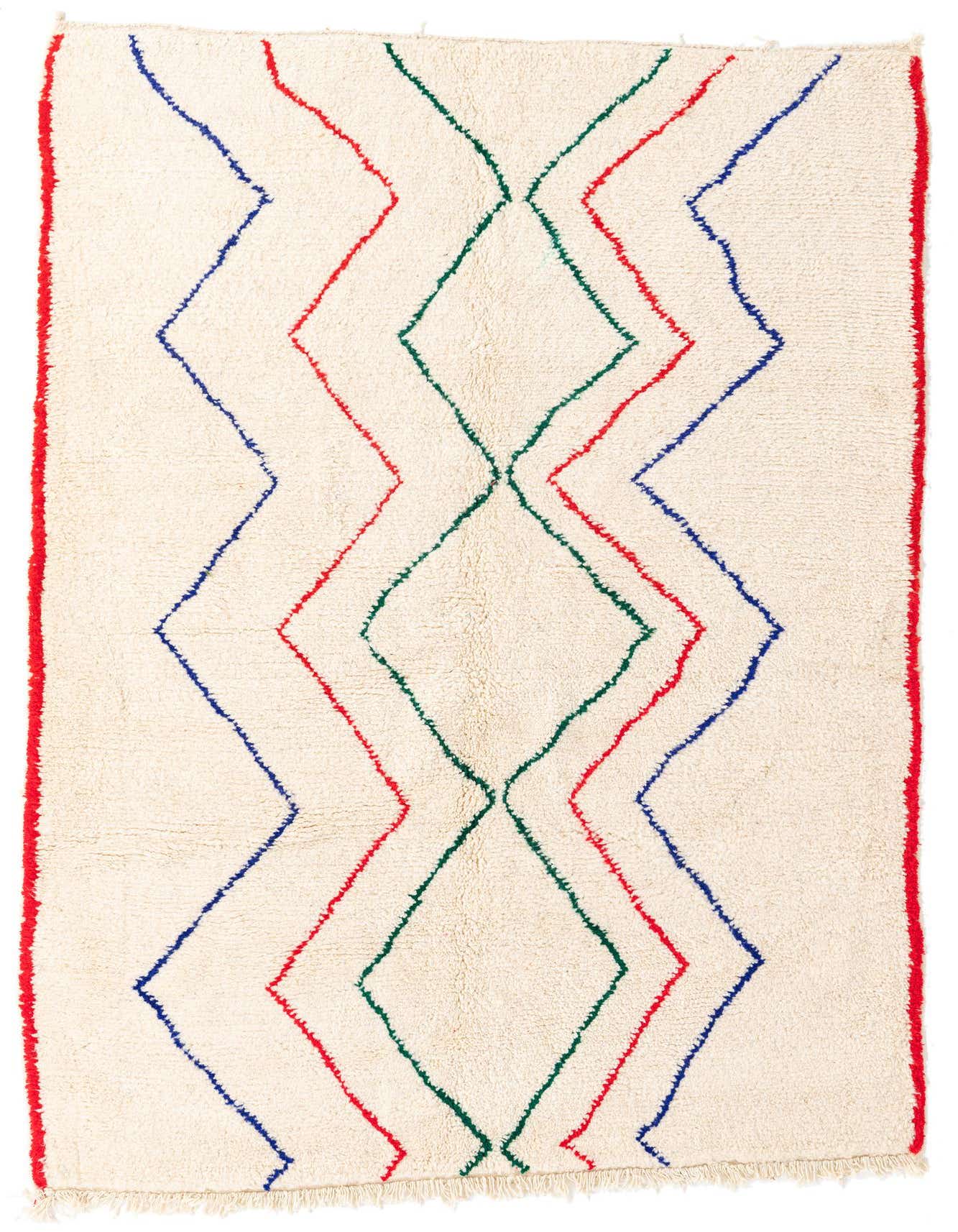 A 5x8 rectangular ivory shag rug with bold red, blue, and green tribal zigzag and diamond patterns.