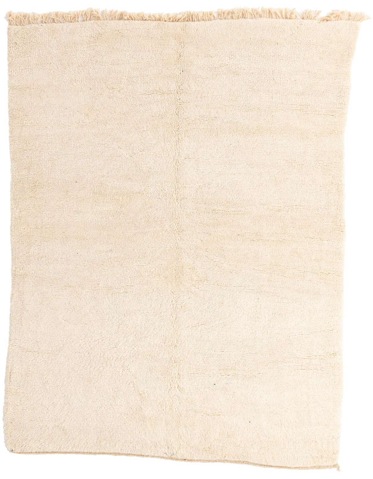 A 6x9 rectangular ivory shag rug with a subtle tribal pattern and fringed edges, perfect for a living room.