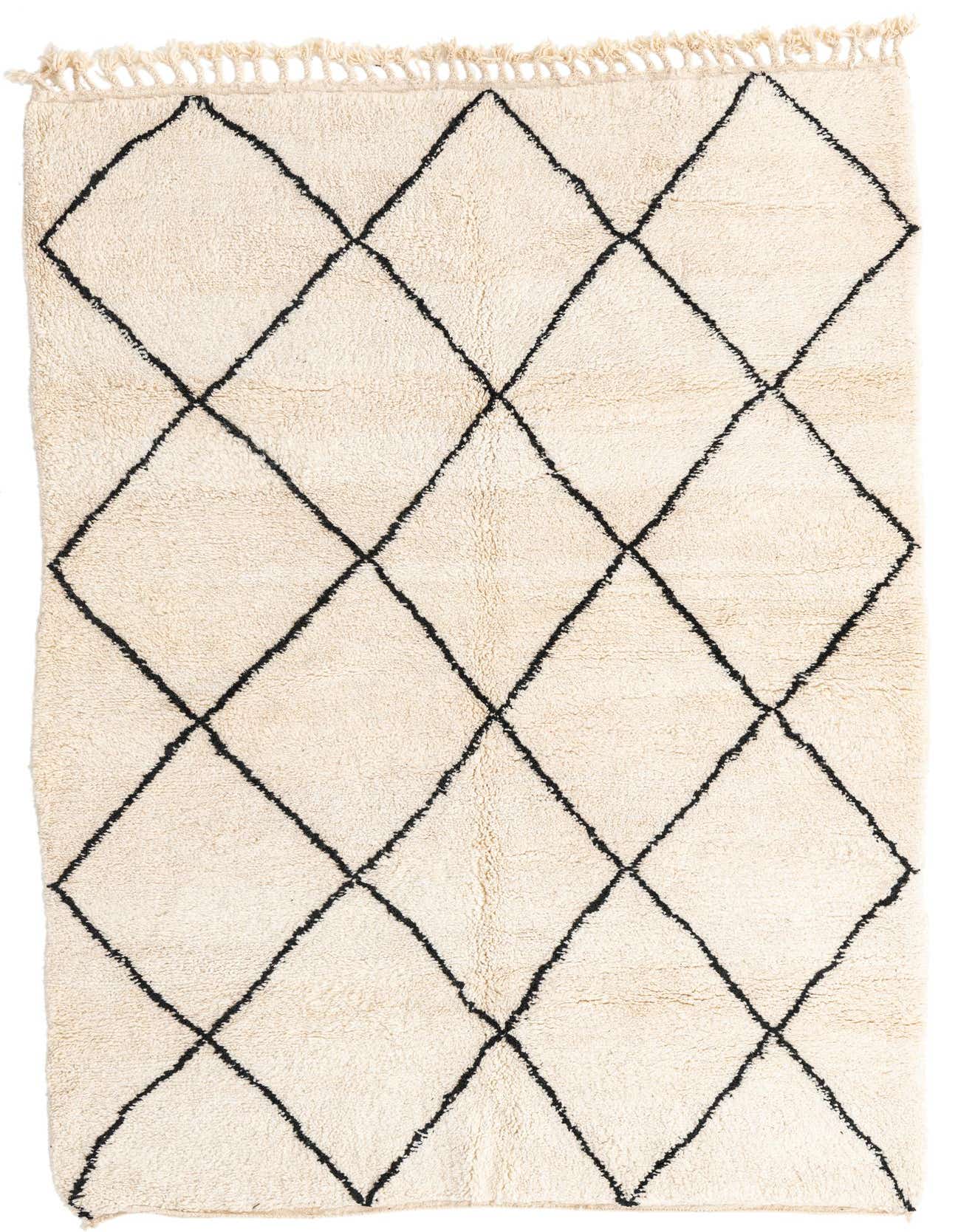 A 5x8 rectangular ivory shag rug with a black tribal diamond pattern and fringed ends, suitable for a living room.