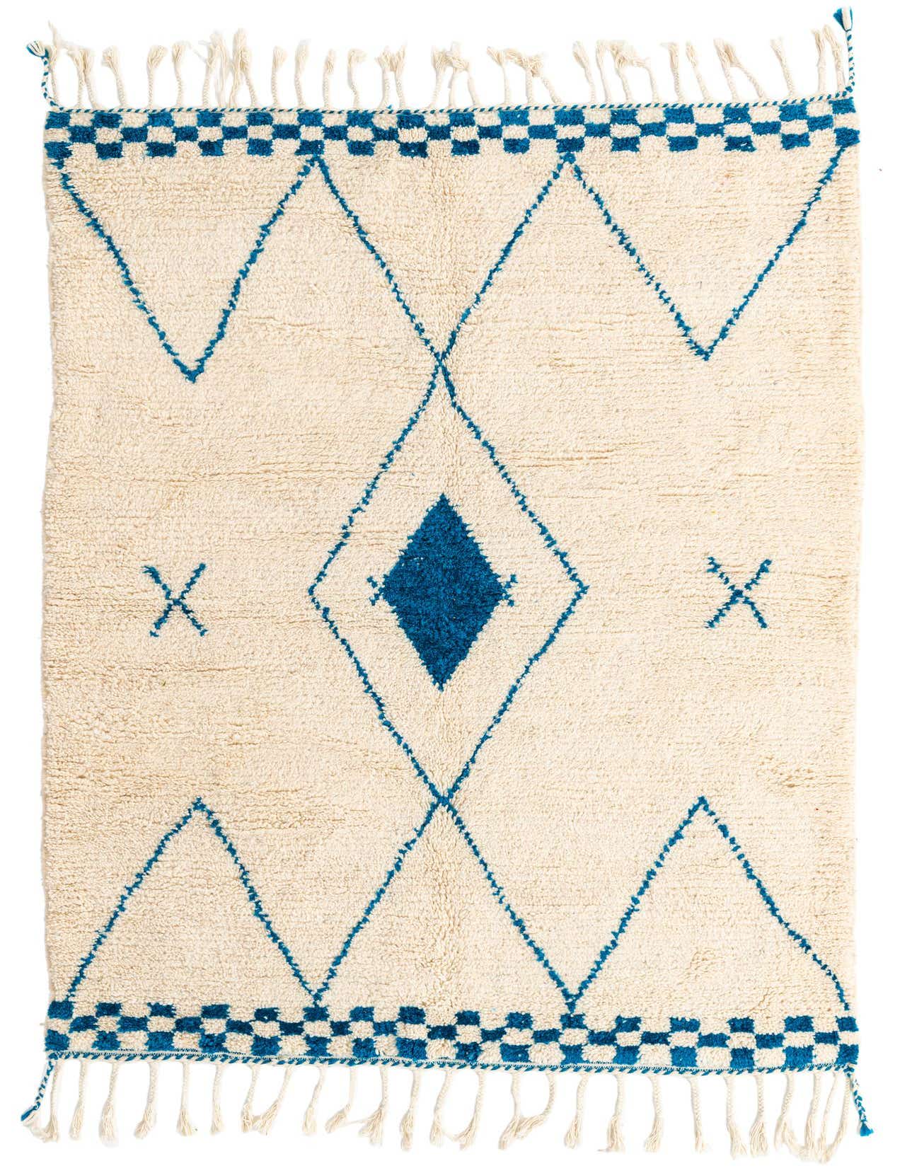 A 5x8 rectangular ivory shag rug with a blue tribal diamond and 'X' pattern, featuring checkered borders and tassels.