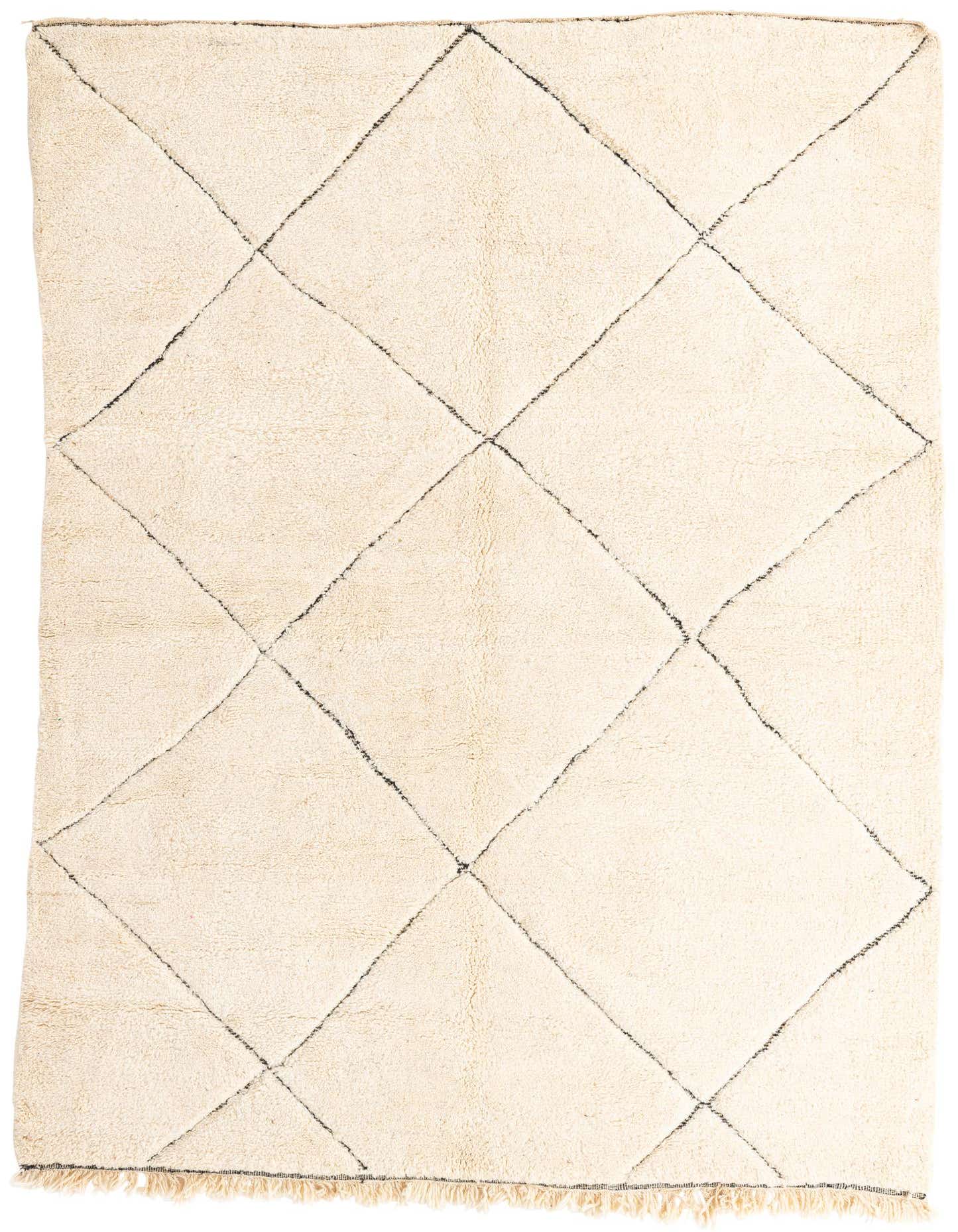 A 7x10 rectangular ivory shag rug with a black tribal diamond pattern and fringed edges, suitable for a living room.