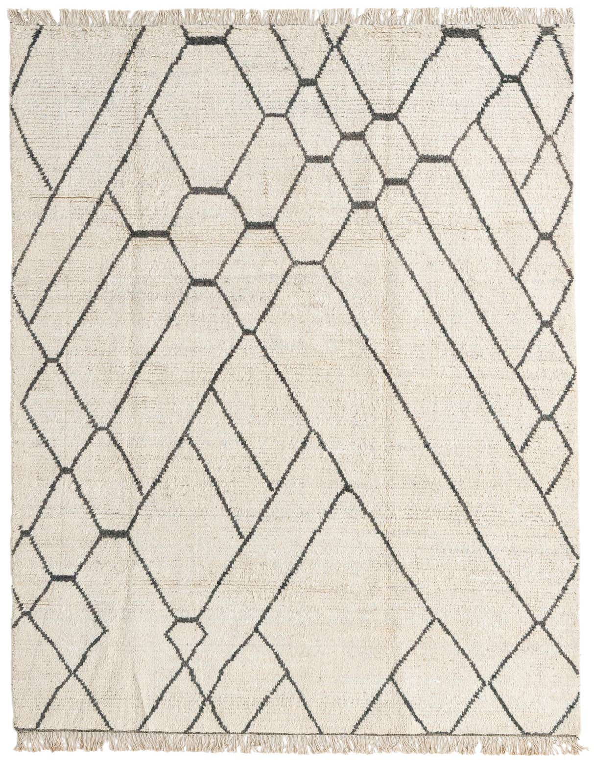 A 6x9 rectangular ivory shag rug with a modern tribal geometric pattern in dark gray, featuring fringe.