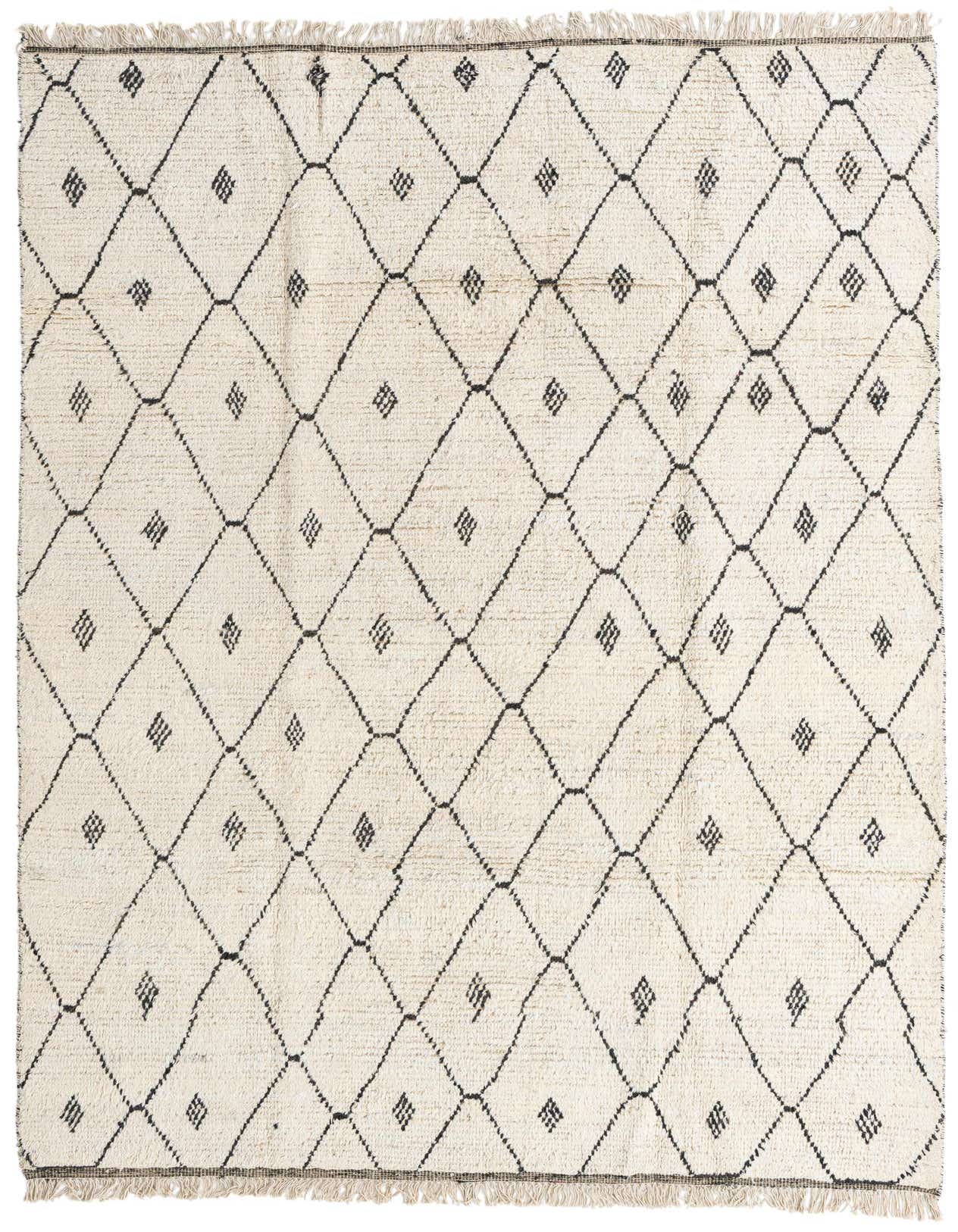 A 6x9 rectangular ivory shag rug with a black tribal diamond pattern and fringed edges, perfect for a modern living room.