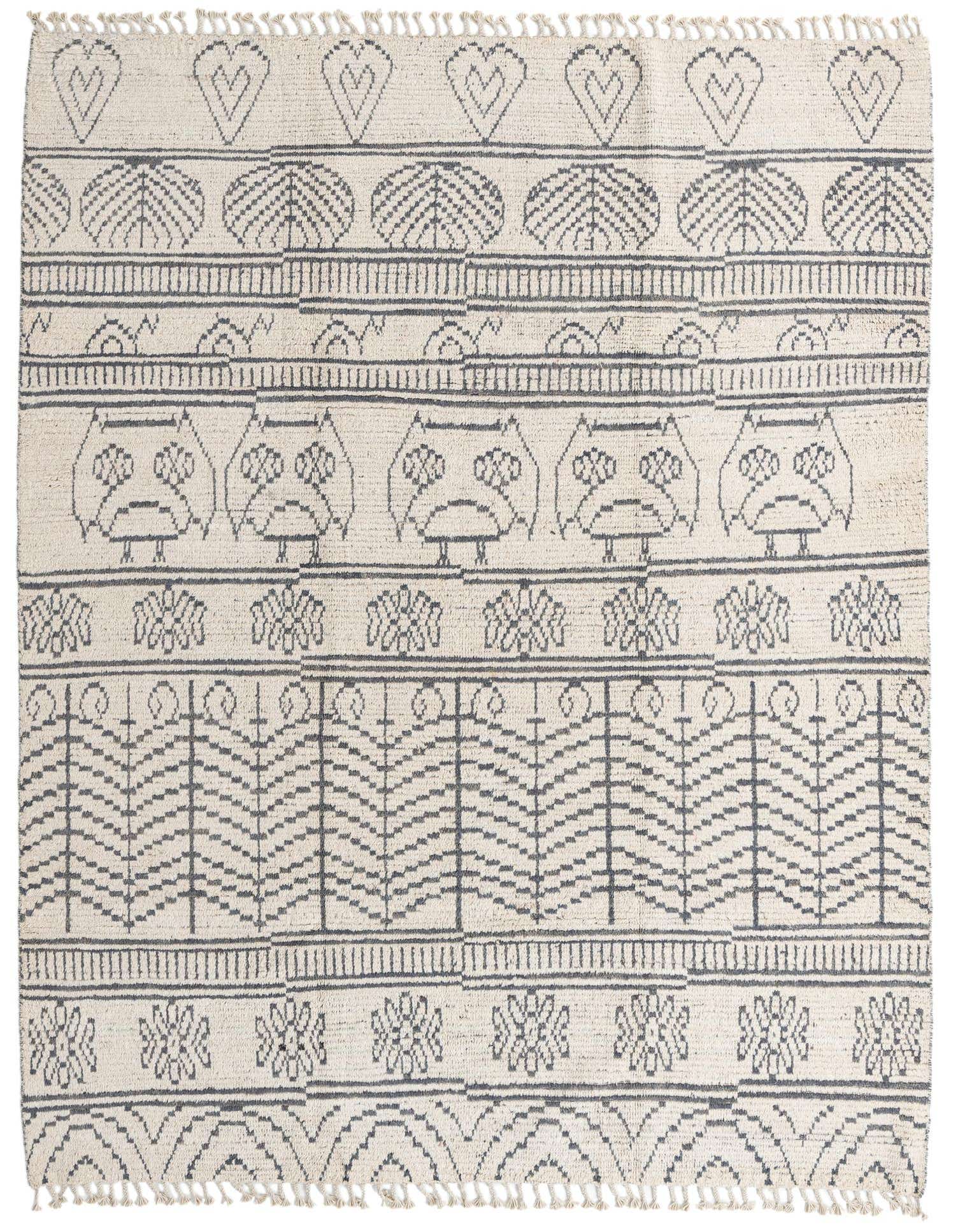 An 8x10 rectangular ivory wool shag rug with a modern tribal pattern featuring dark gray owls, hearts, and abstract motifs.