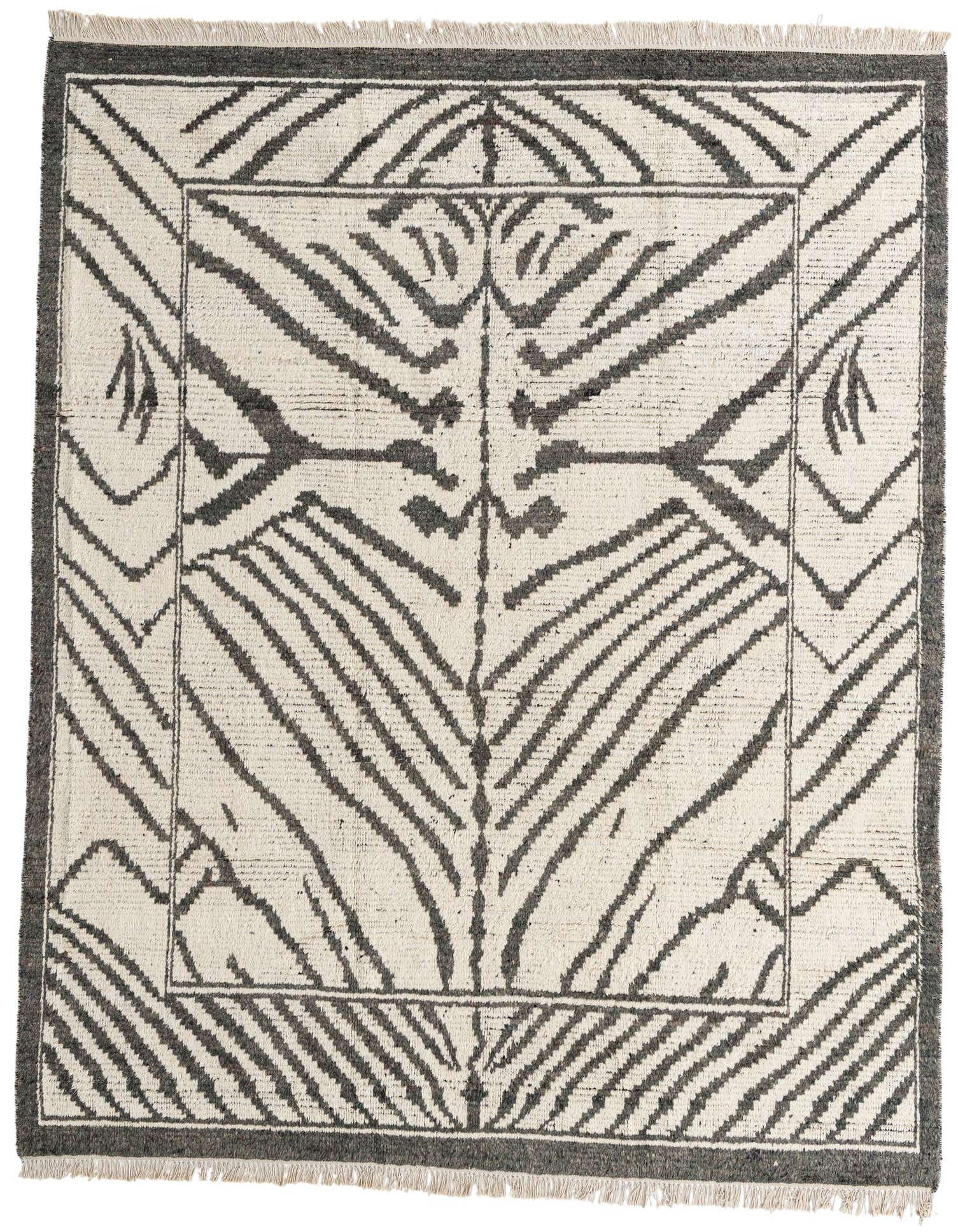 An 8x10 rectangular ivory shag rug with a bold, dark gray abstract tribal pattern, featuring a central motif and framed border.