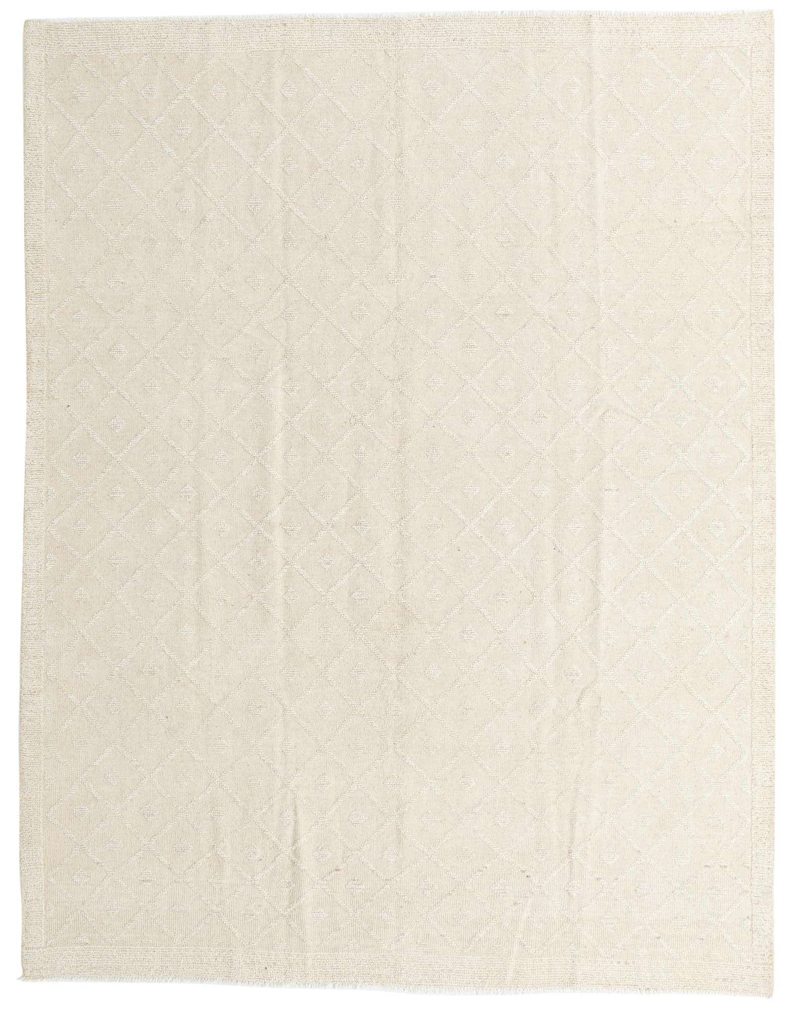 An 8x10 rectangular ivory wool shag rug with a subtle tribal diamond pattern, perfect for a modern living room.