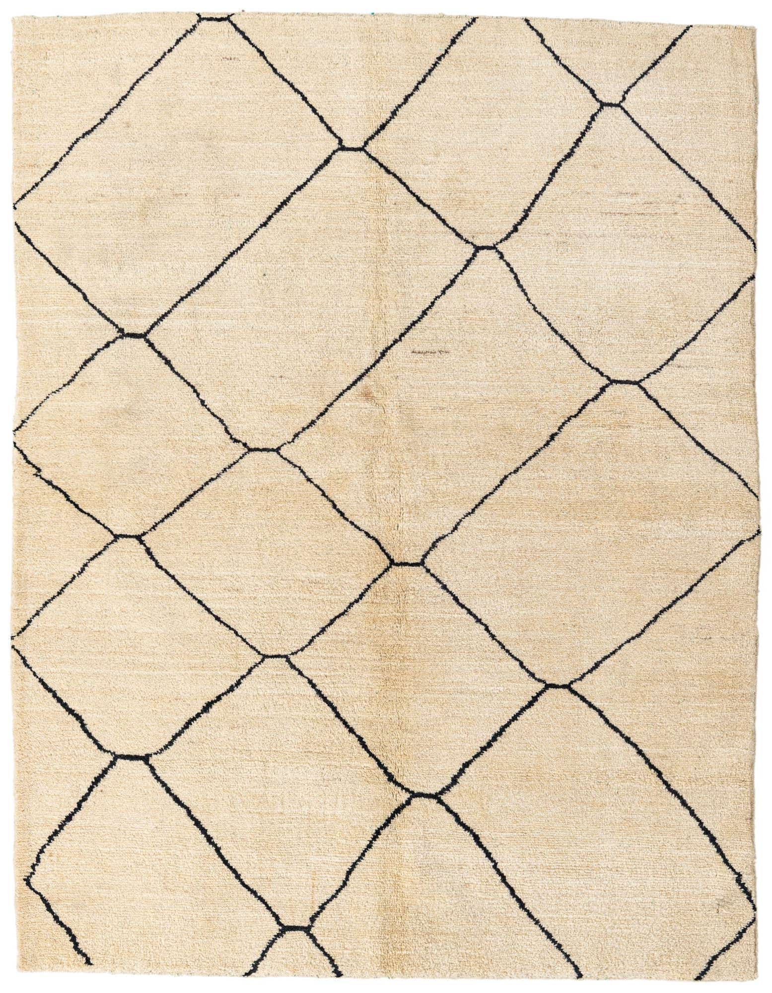 A 5x8 rectangular ivory shag rug with a bold black tribal diamond pattern, ideal for a living room.