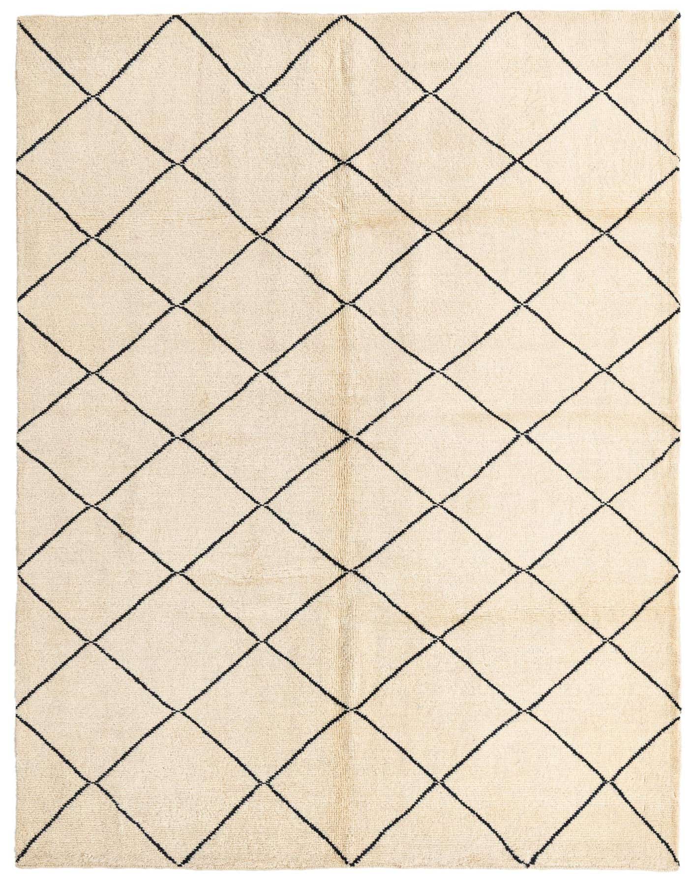 A 6x9 rectangular ivory shag rug with a black tribal diamond pattern, ideal for a living room or bedroom.