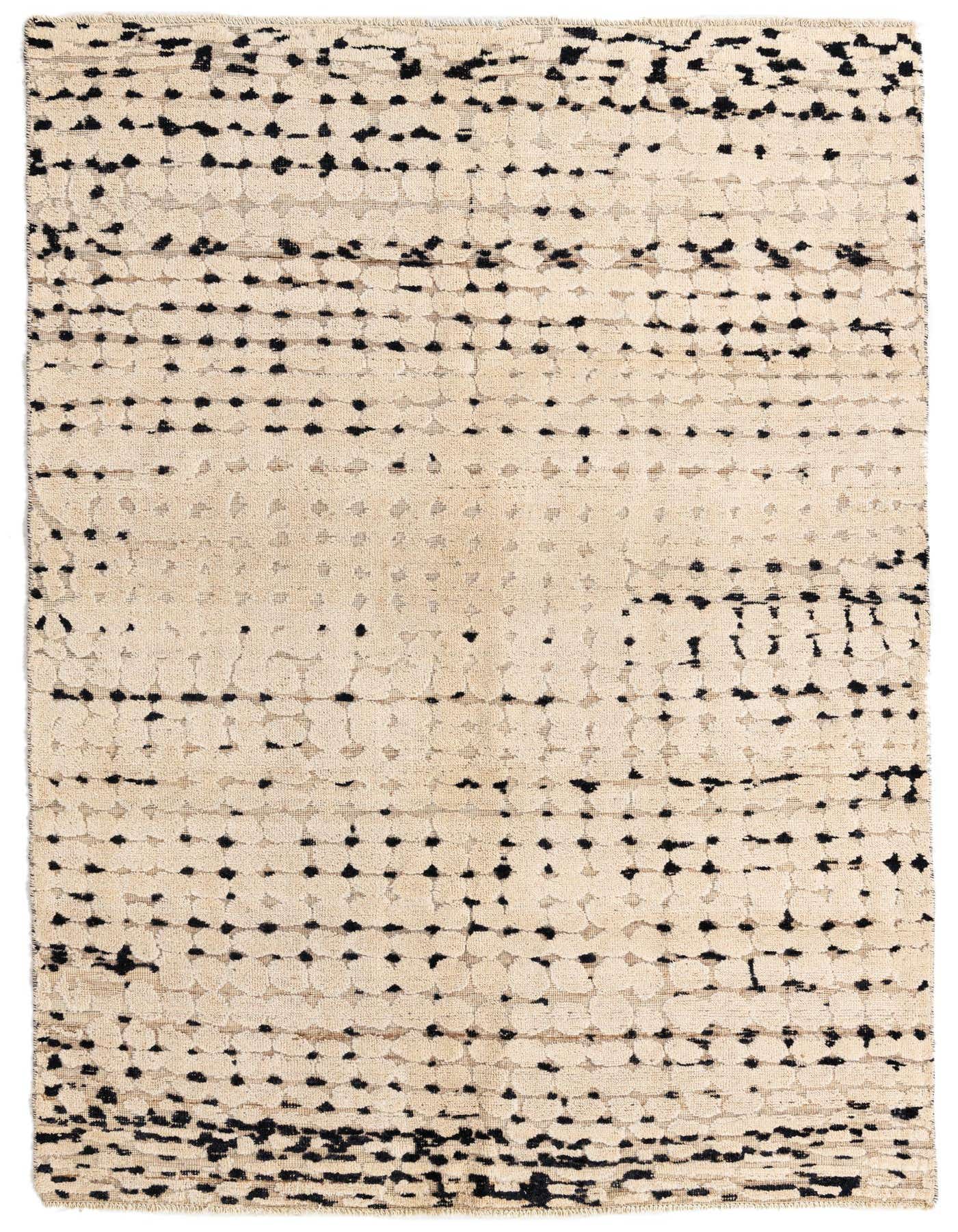 A 5x8 rectangular ivory shag rug with an abstract tribal pattern of scattered black dots and dashes.