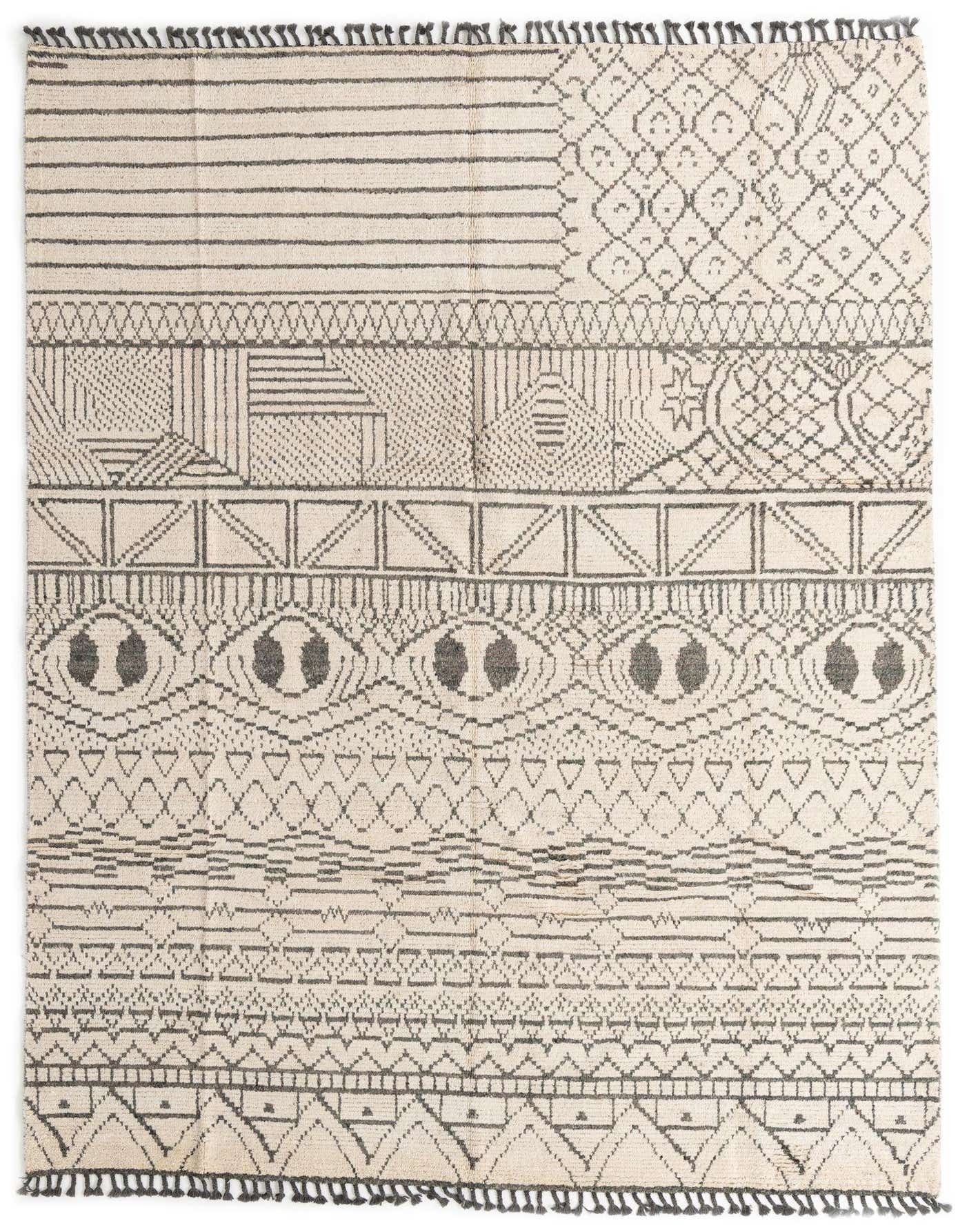 A 9x12 rectangular ivory wool shag rug with a modern tribal pattern in charcoal gray, featuring abstract shapes and lines.