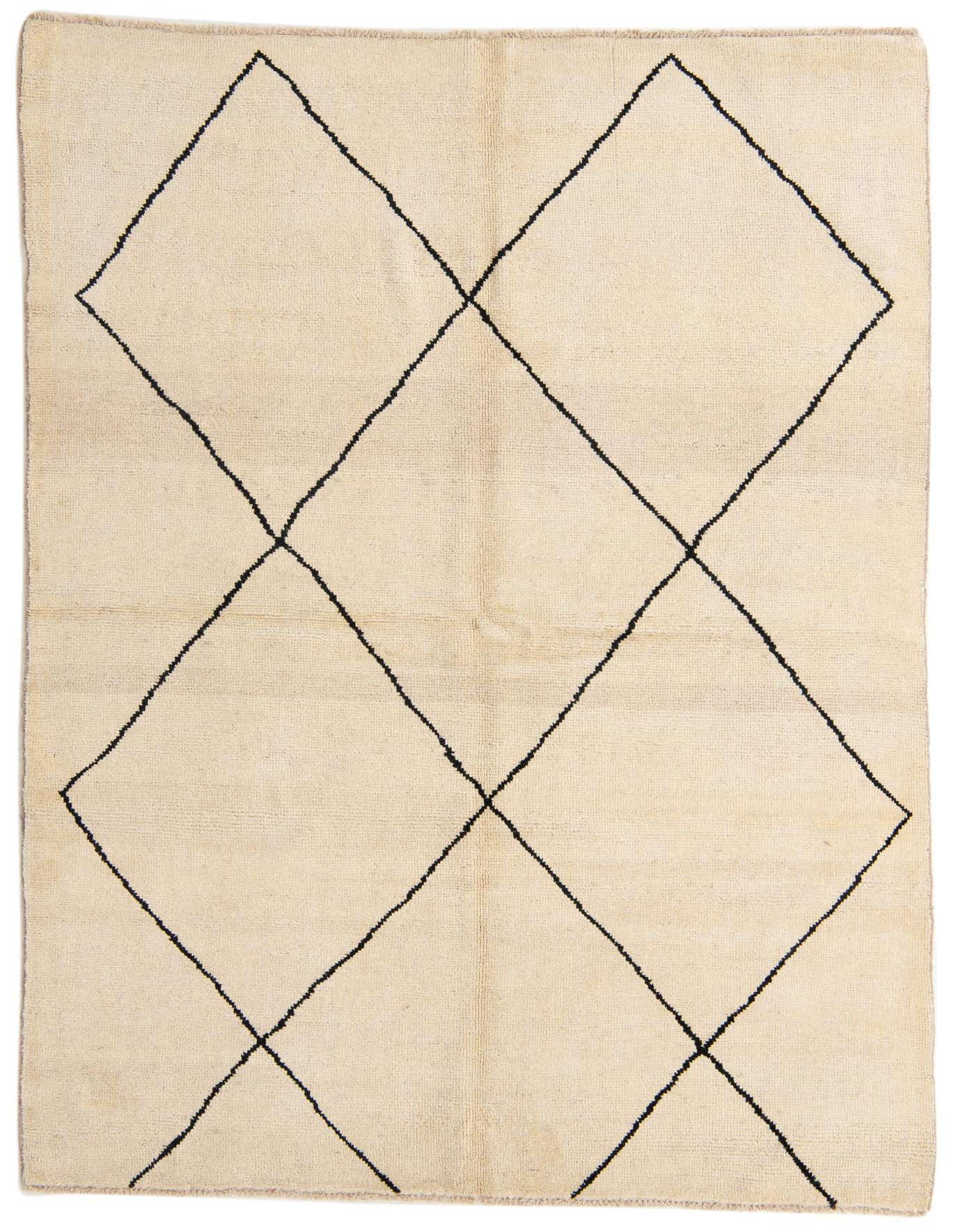 A 5x8 rectangular ivory shag rug with a bold black tribal diamond pattern, ideal for a modern living room.
