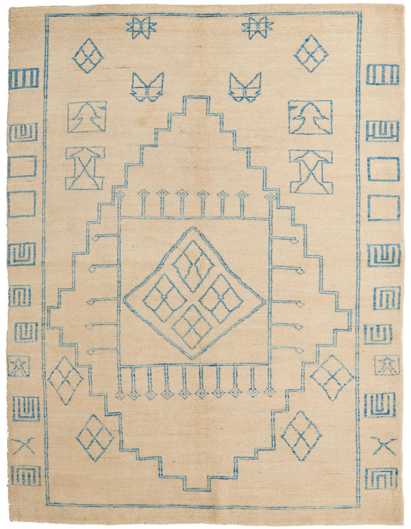 A 6x9 rectangular ivory wool shag rug with a modern tribal pattern in blue, perfect for a living room.