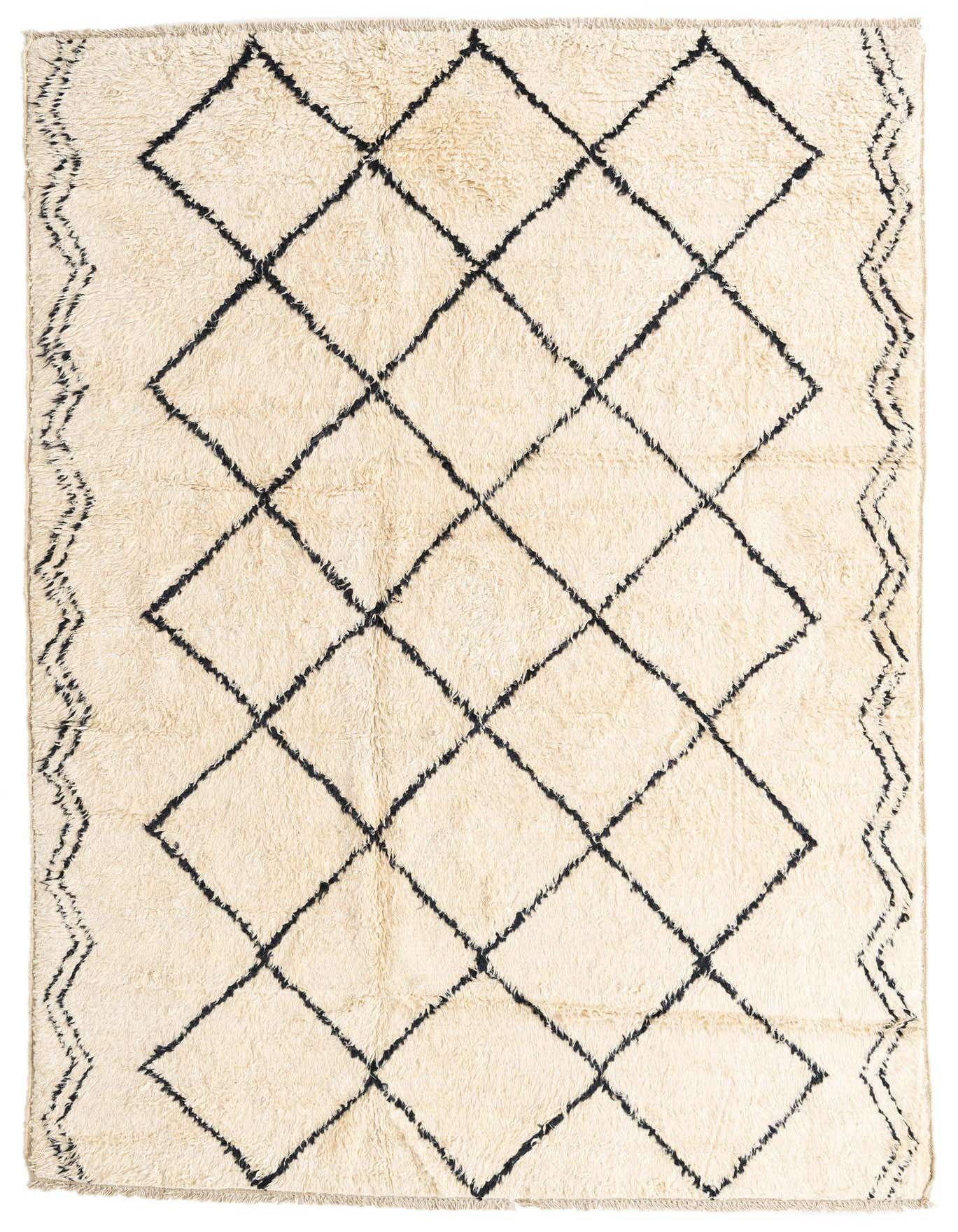 A rectangular 6x9 ivory shag rug with a black tribal diamond pattern and zigzag border, suitable for a living room.