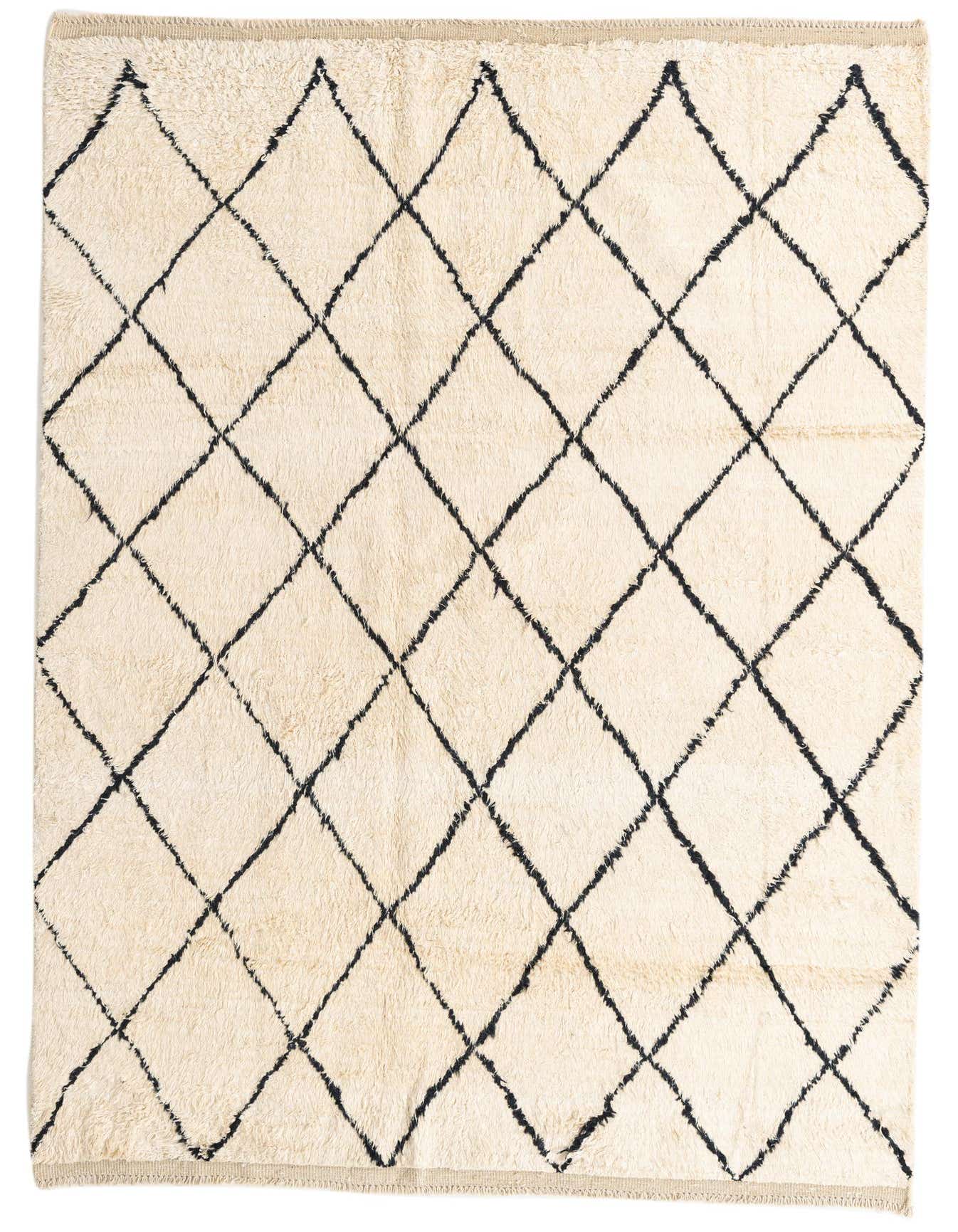 A 6x9 rectangular ivory shag rug with a bold black tribal diamond pattern, perfect for a modern living room.