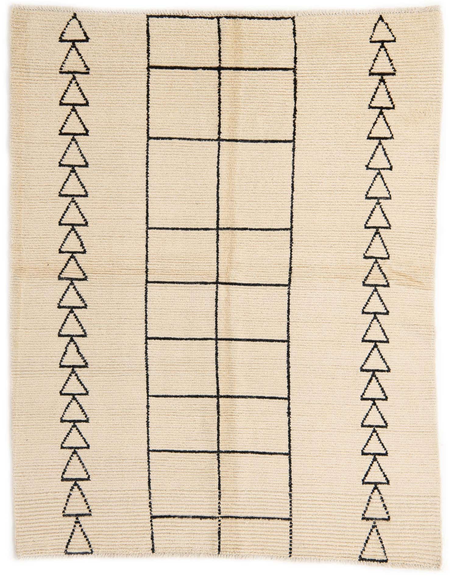 A 5x8 rectangular ivory wool shag rug with a modern tribal pattern featuring black geometric shapes and triangles.