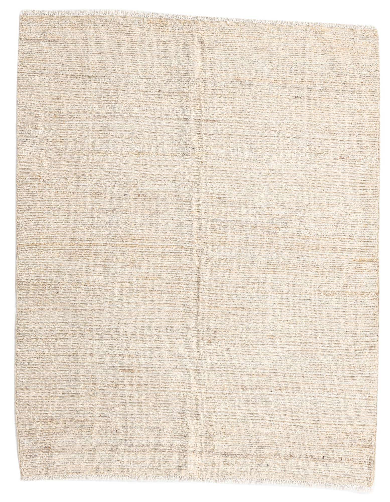 A 5x8 rectangular ivory shag rug with a subtle tribal texture, perfect for a modern living room.