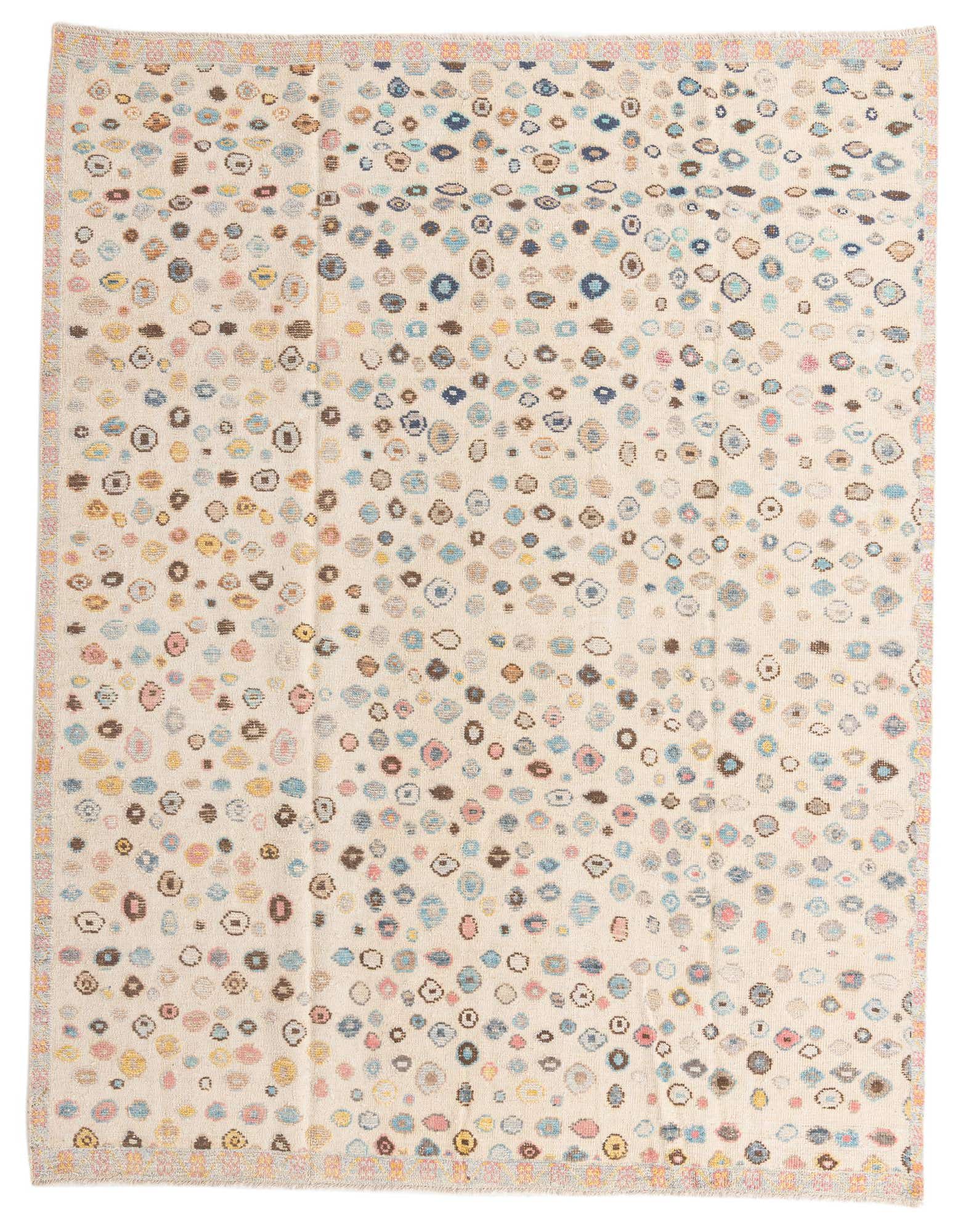 8x10 rectangular ivory wool shag rug with a playful, colorful abstract tribal pattern of scattered ovals and circles.