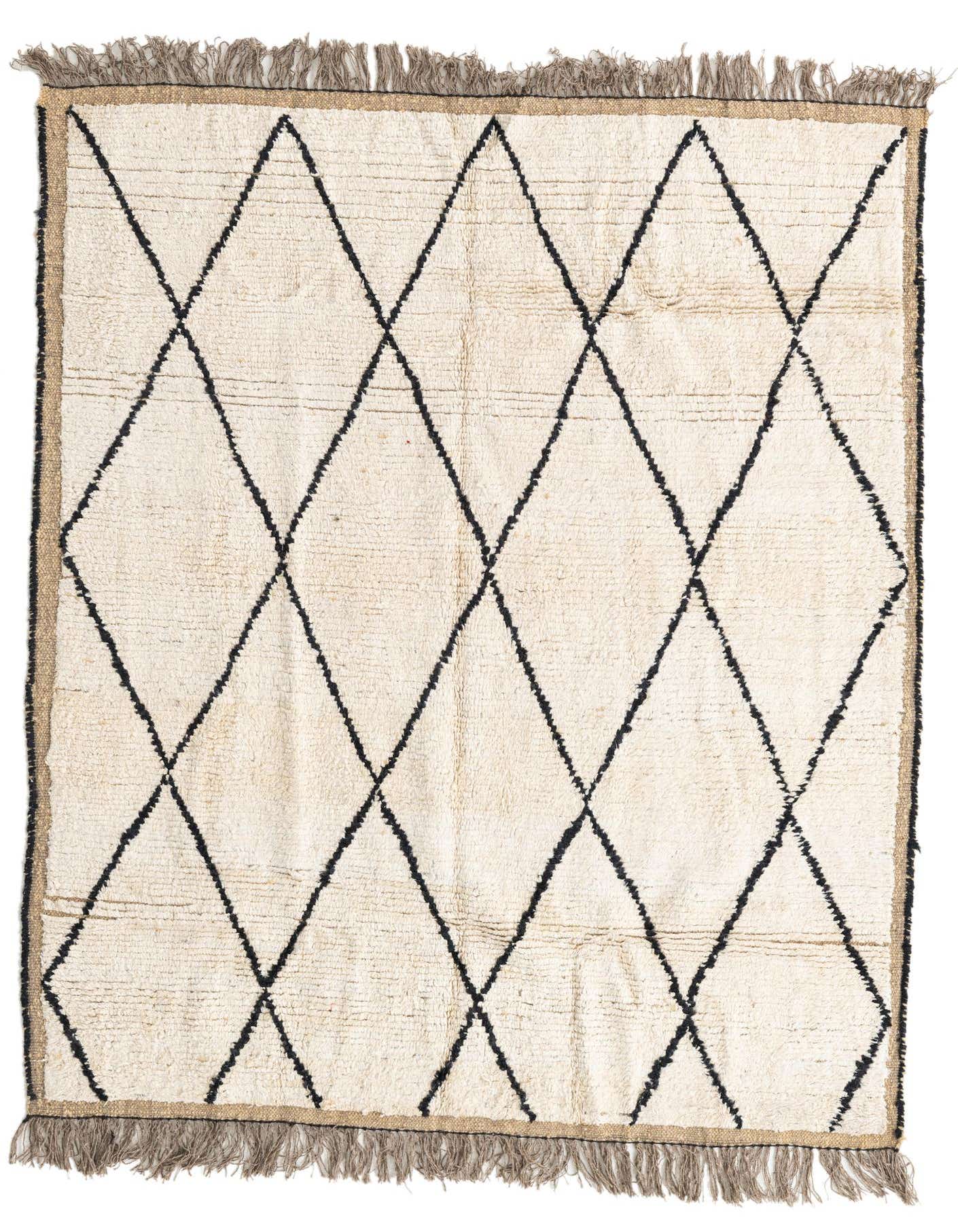 A 5x8 rectangular ivory shag rug with a bold black tribal diamond pattern and fringed ends, perfect for a modern living room.