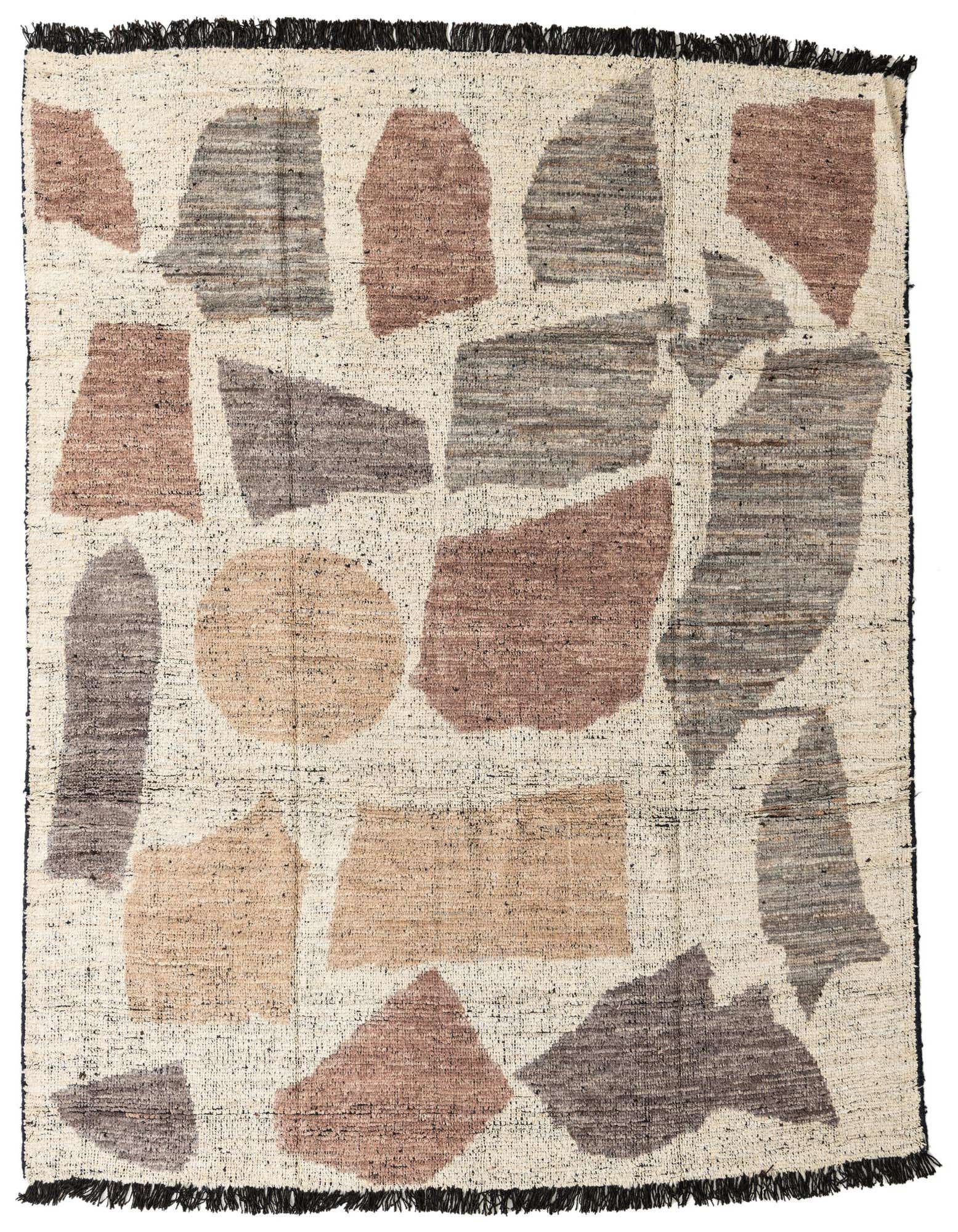 An 8x10 rectangular ivory shag rug with abstract tribal shapes in muted browns, grays, and creams, featuring black fringe.