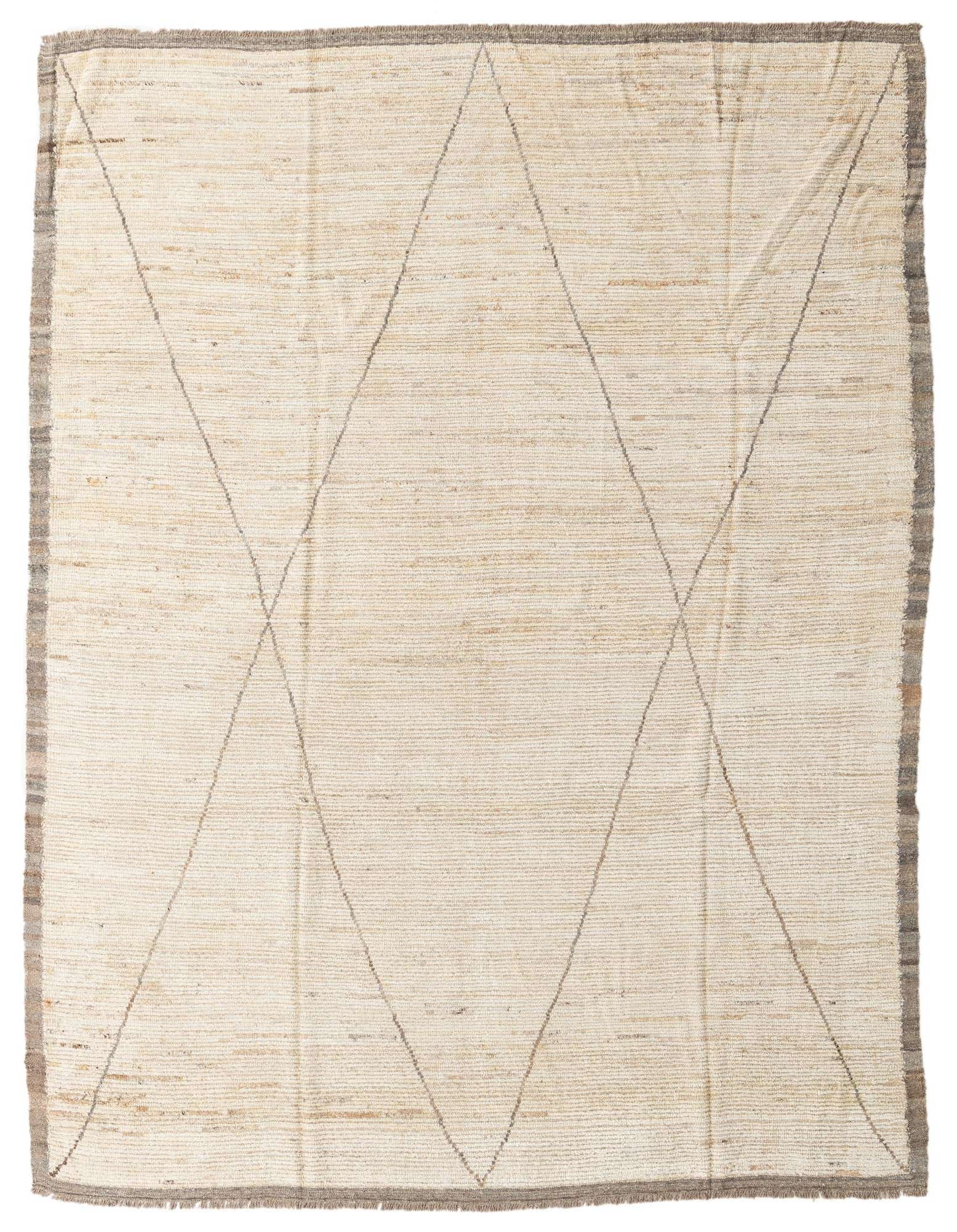 An 8x10 rectangular ivory wool shag rug with a subtle tribal diamond pattern and a dark border.