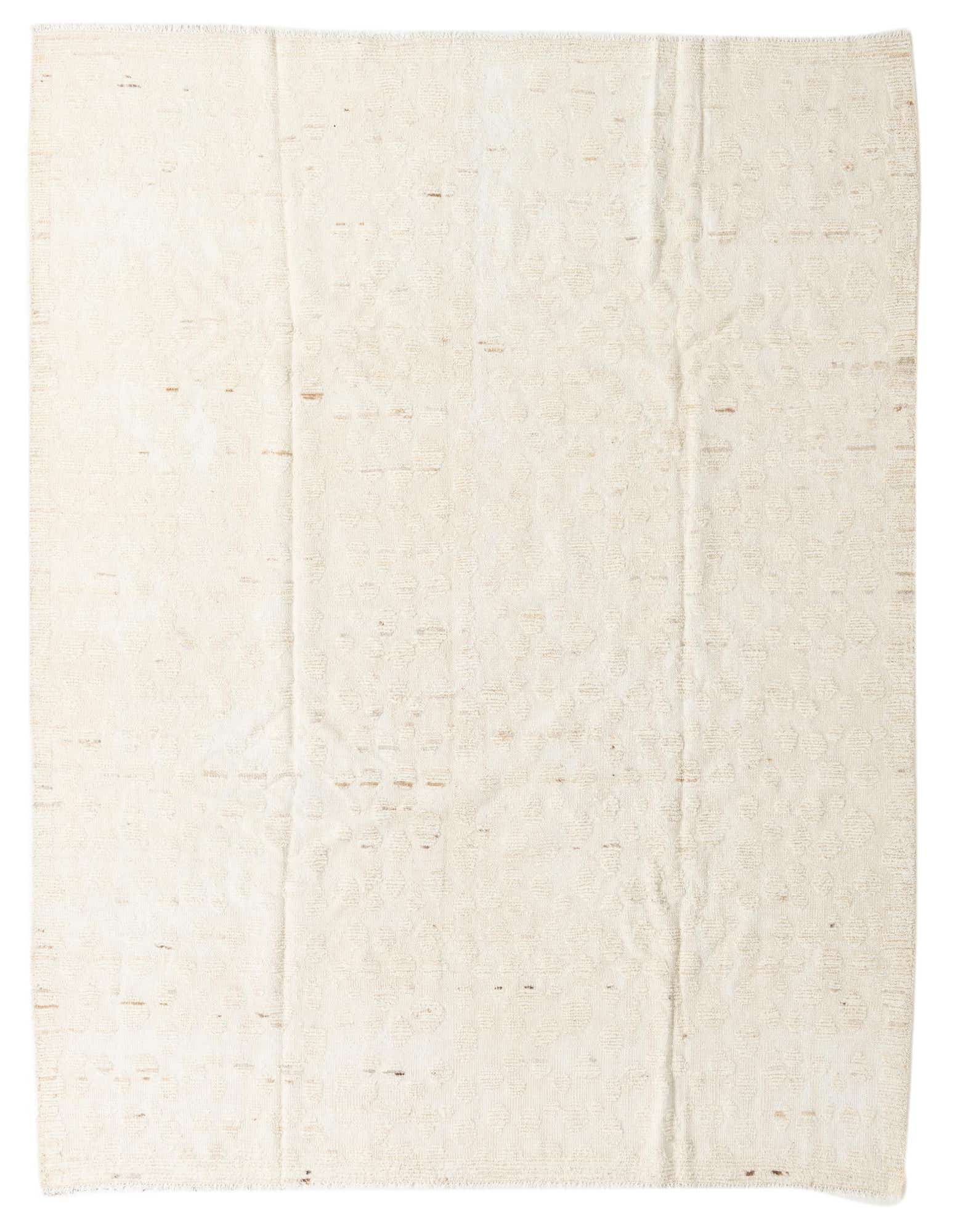 An 8x10 rectangular ivory wool shag rug with a subtle tribal pattern, ideal for a living room.