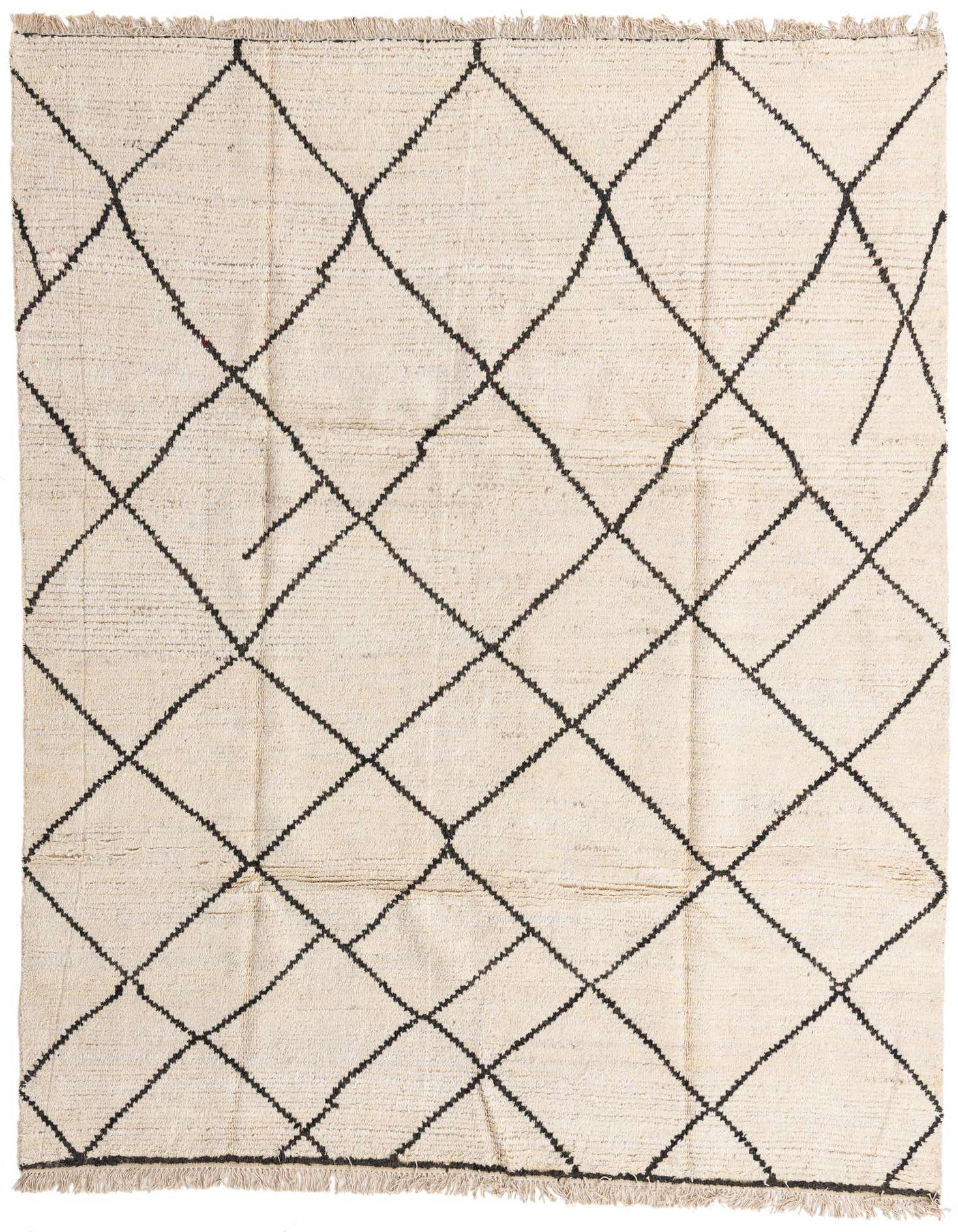An 8x10 rectangular ivory shag rug with a black tribal diamond pattern and fringed edges.
