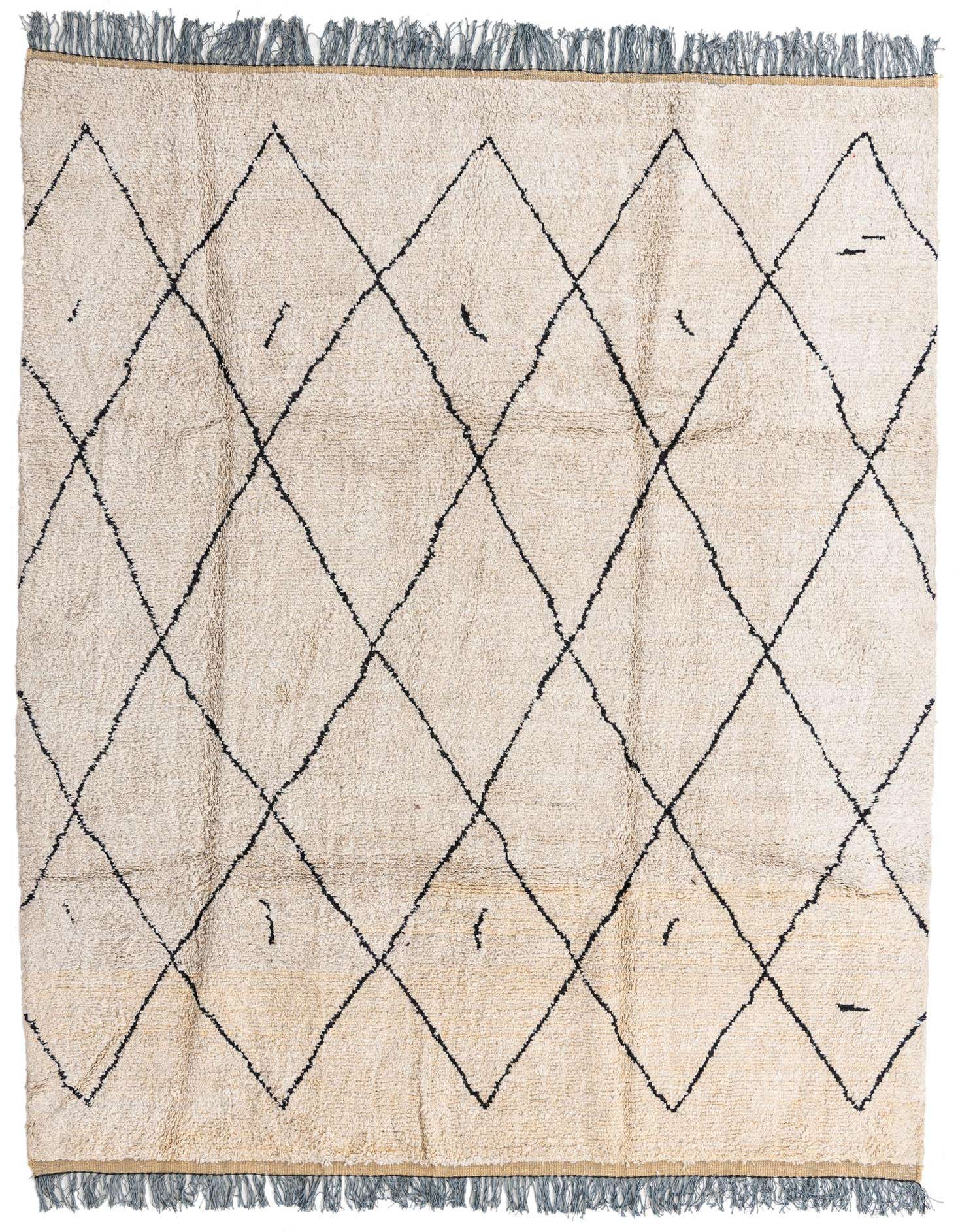 An 8x10 rectangular ivory shag rug with a black tribal diamond pattern and fringed edges, suitable for a living room.