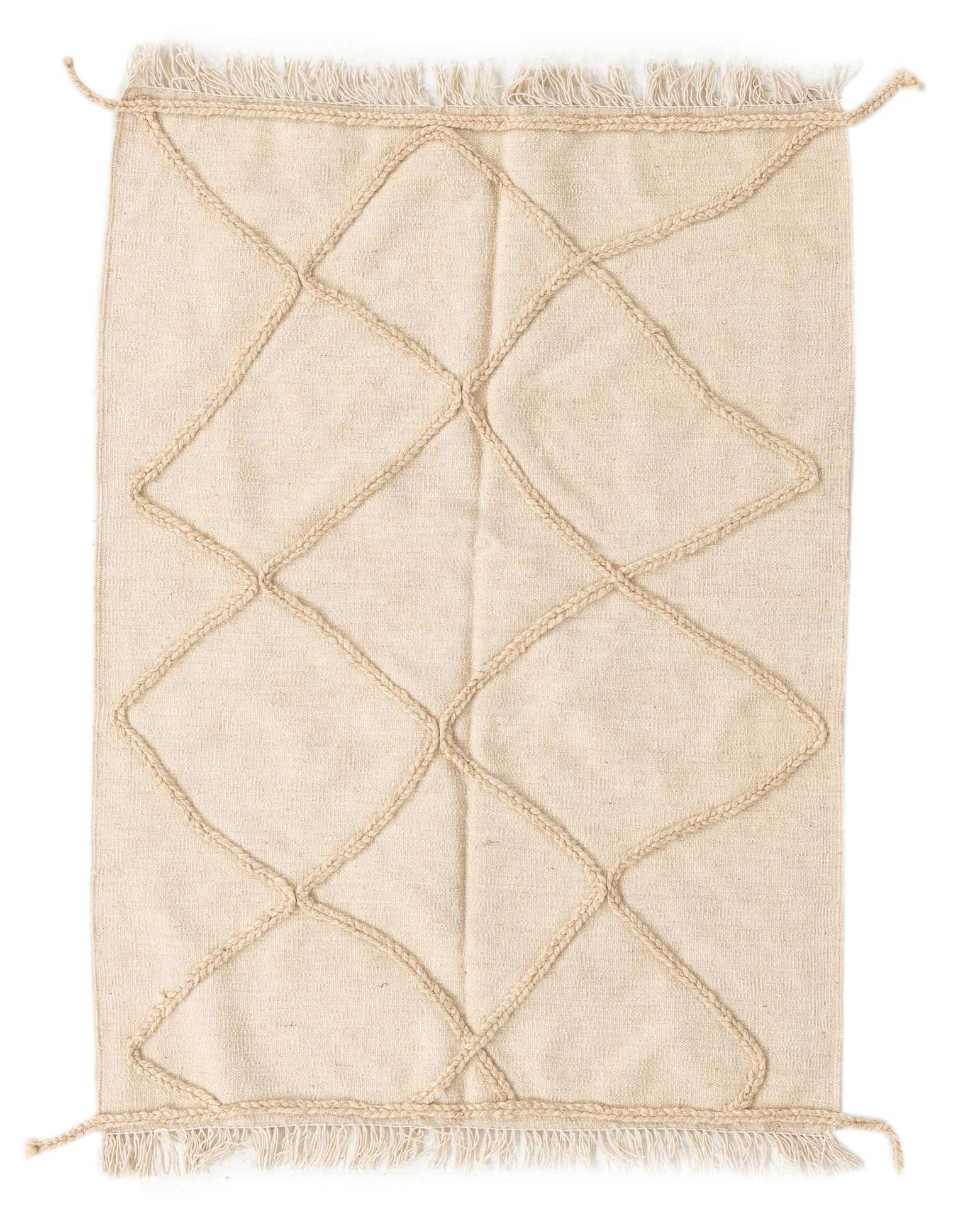 A 3x5 rectangular ivory wool shag rug with a raised braided tribal diamond pattern and fringed edges.