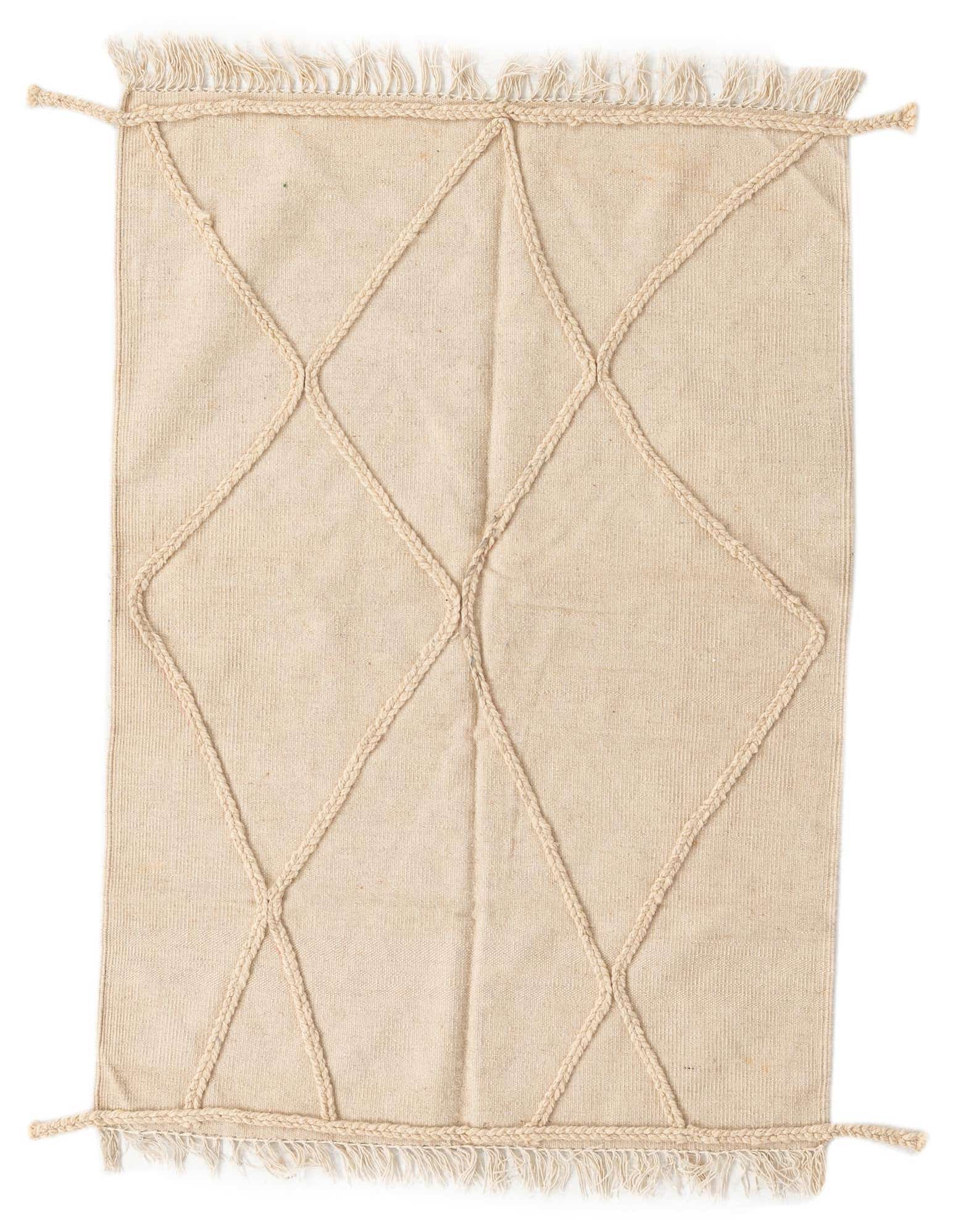 A 3x5 rectangular ivory wool shag rug with a raised braided diamond pattern and fringe tassels.