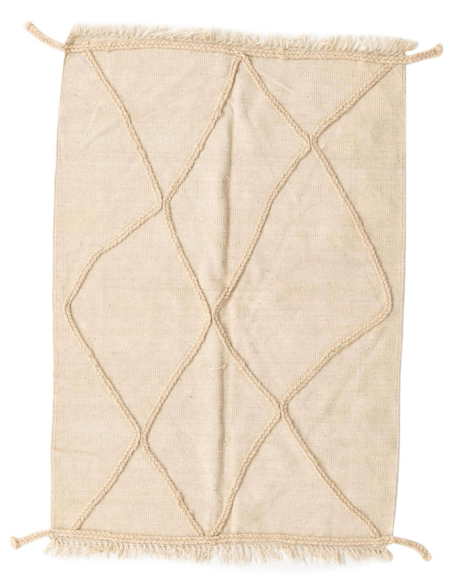 A 3x5 rectangular ivory wool shag rug with a raised braided diamond pattern and fringed edges.
