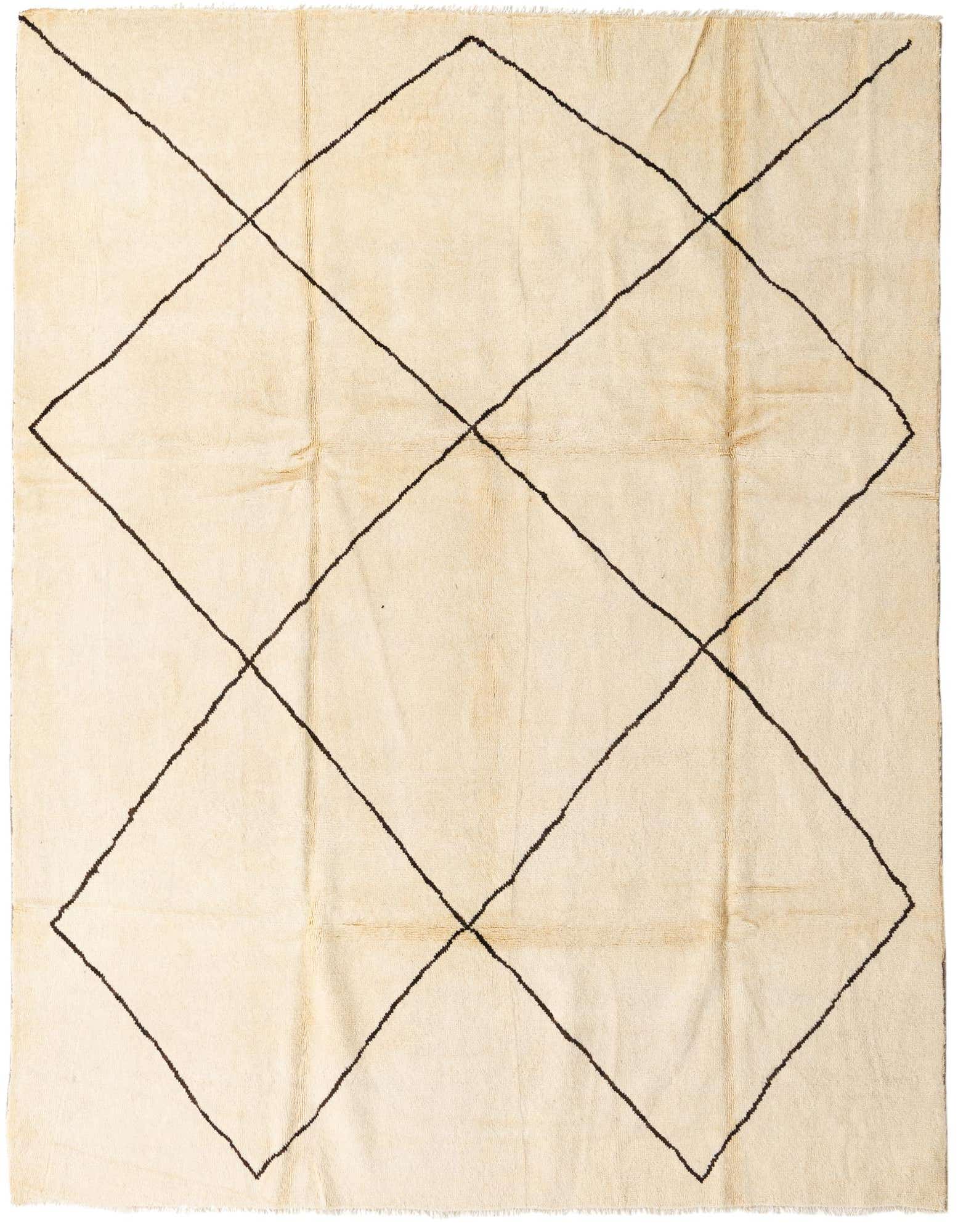 An 8x10 rectangular ivory shag rug with a bold black tribal diamond pattern, ideal for a living room.