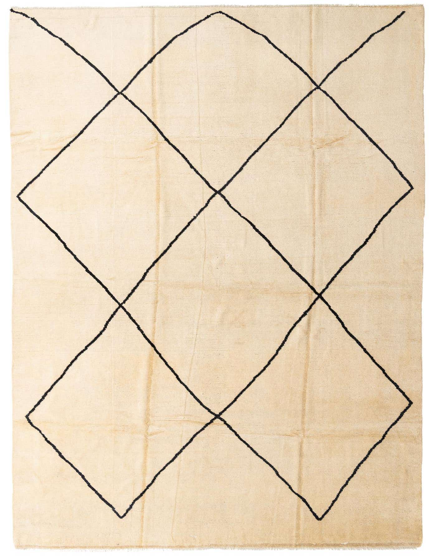 A 10x14 rectangular ivory shag rug with a bold black tribal diamond pattern, perfect for a modern living room.
