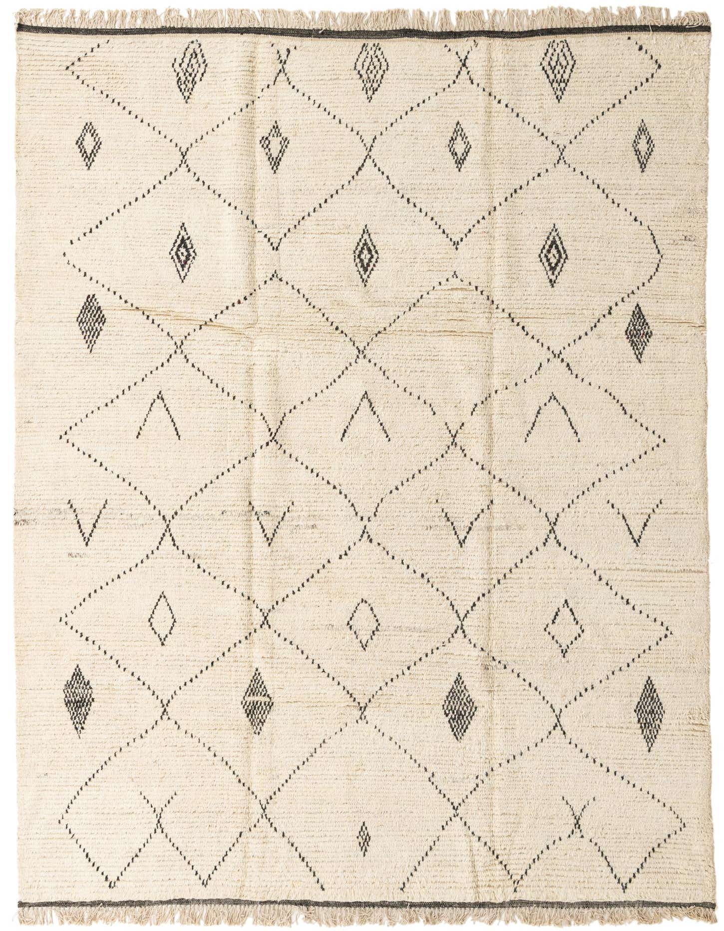 An 8x11 rectangular ivory wool shag rug with a black tribal diamond and dotted line pattern, featuring fringed ends.