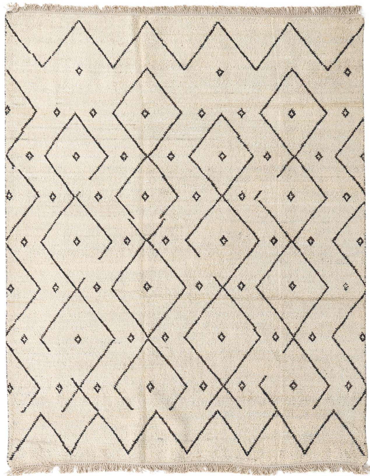 A 6x9 rectangular ivory shag rug with a modern tribal diamond and zigzag pattern in black, suitable for a living room.