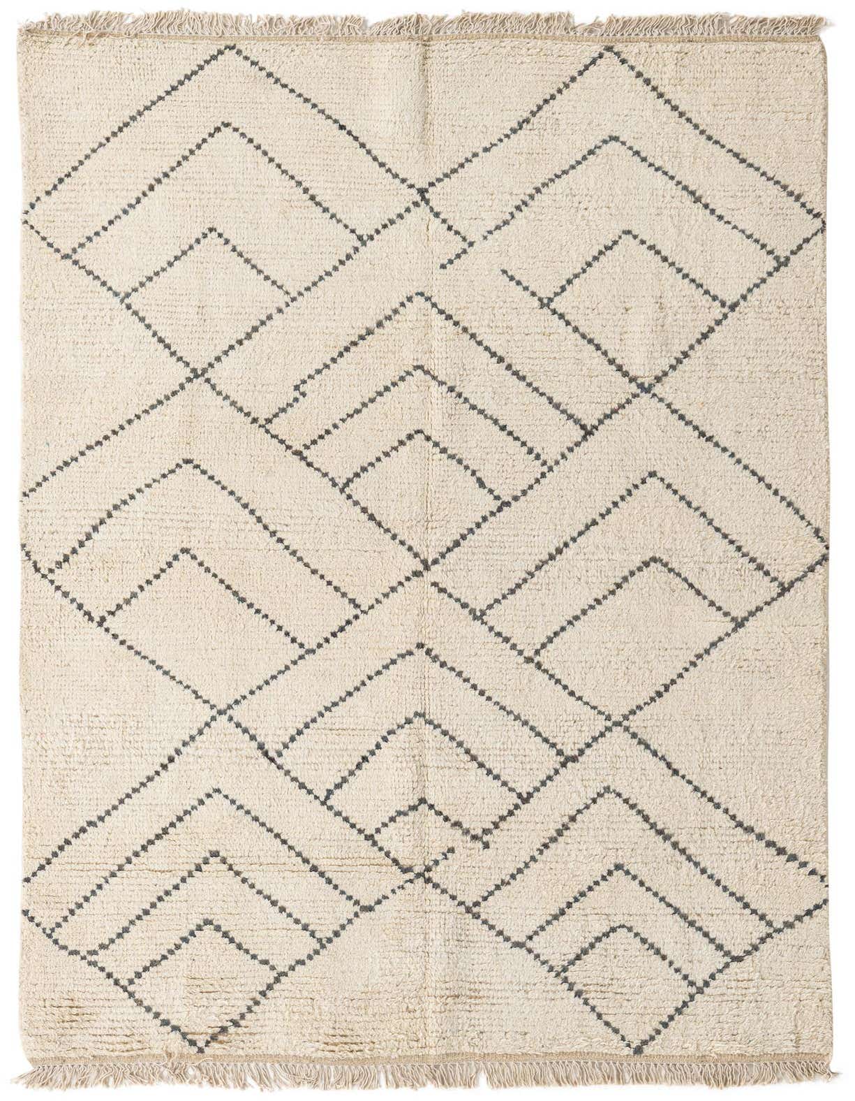 A 5x8 rectangular ivory shag rug with a modern tribal geometric pattern in dark gray, featuring fringe.