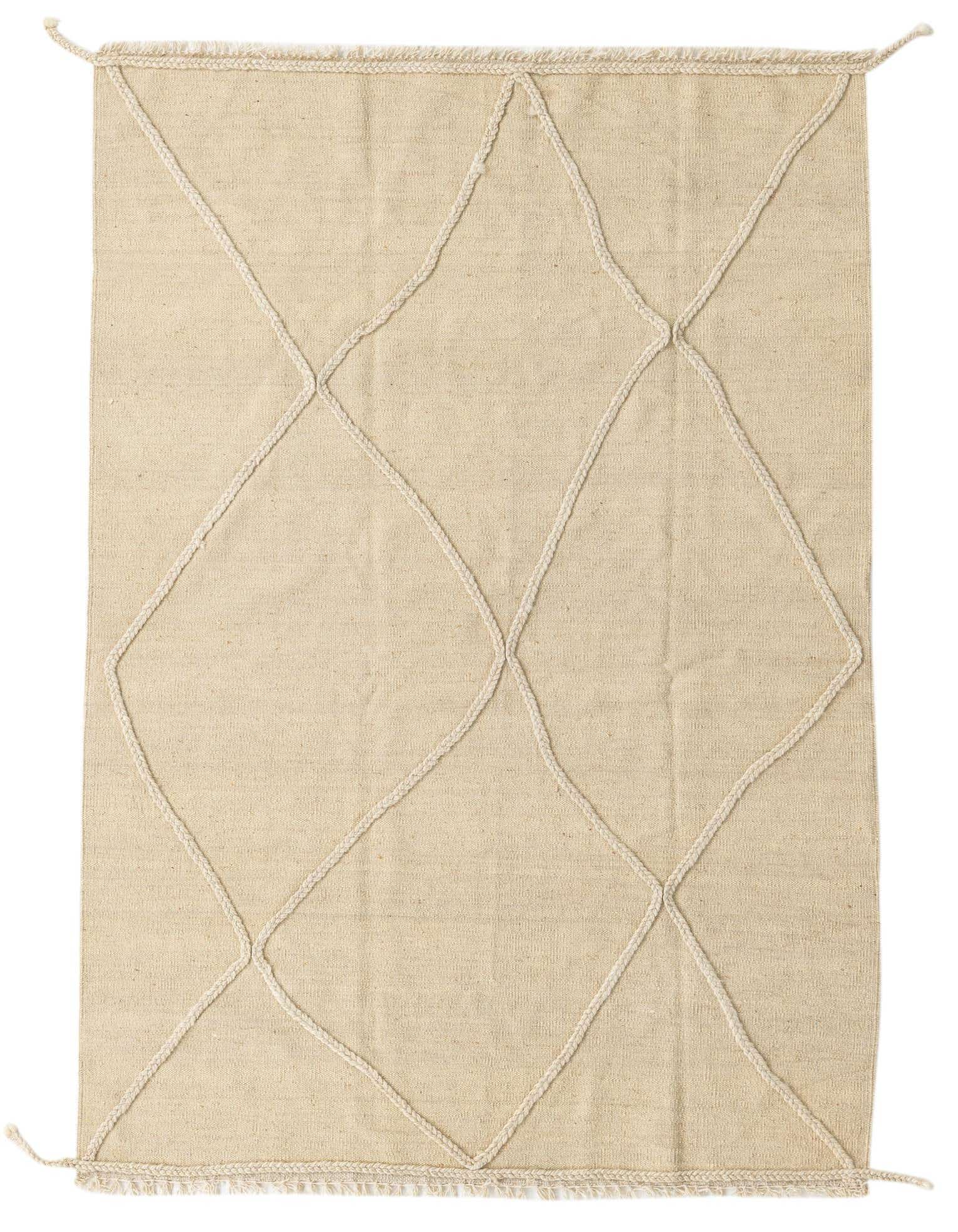 A 4x6 rectangular ivory wool shag rug with a raised tribal diamond pattern and braided tassels.