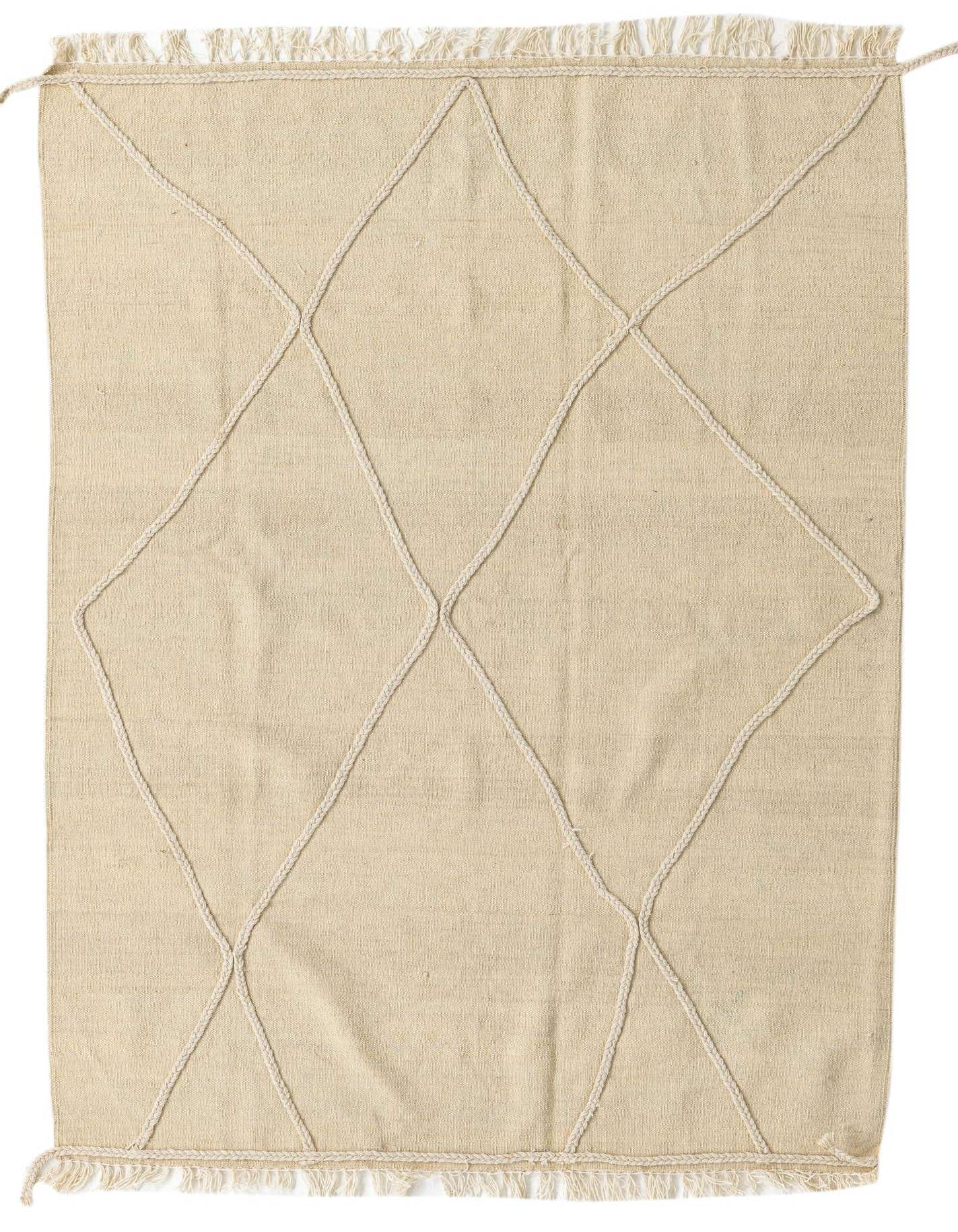 A 4x6 rectangular ivory wool shag rug featuring a modern tribal diamond pattern created with raised white braided lines and fringe.
