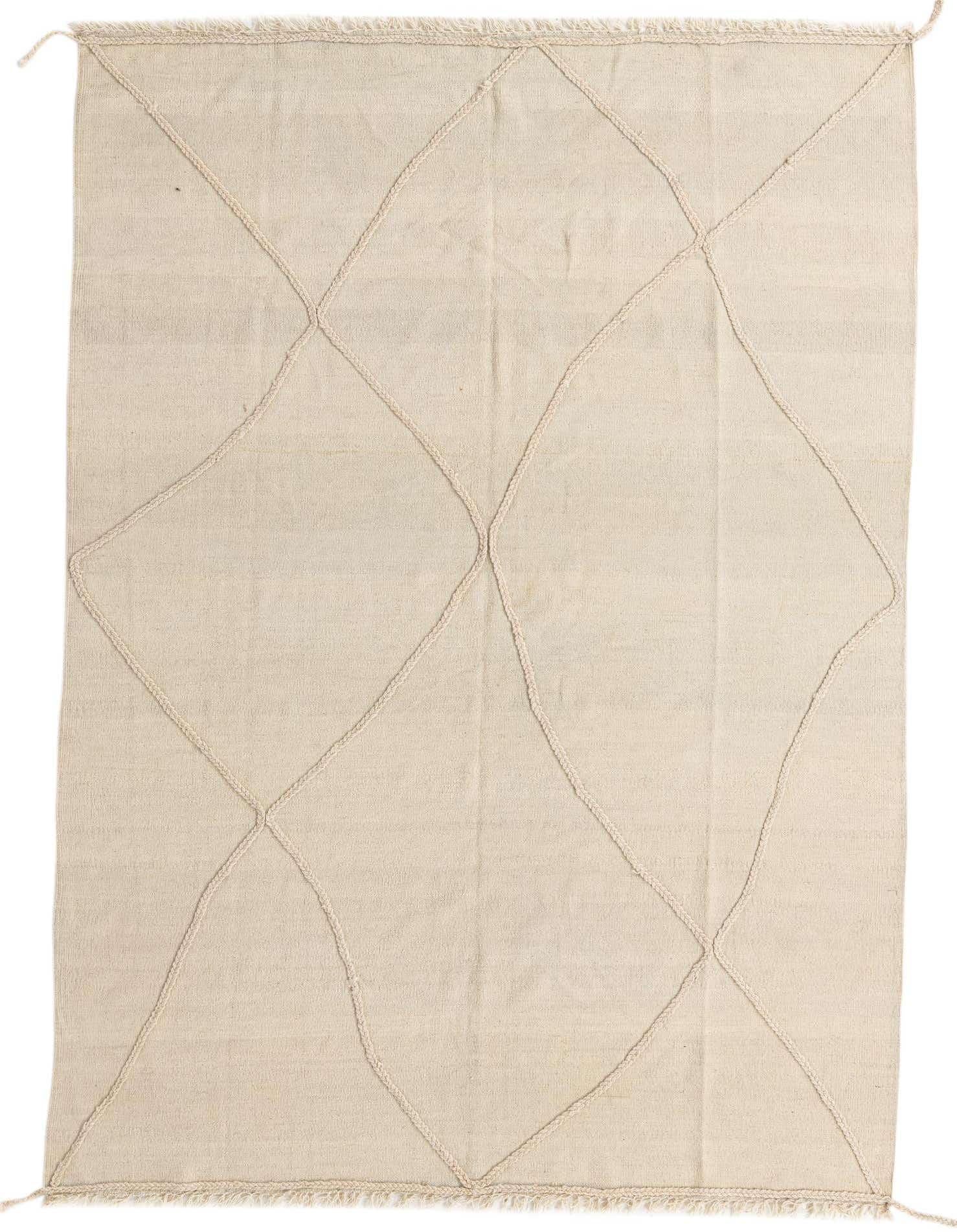 A 5x8 rectangular ivory wool shag rug with a modern tribal diamond pattern, ideal for a living room.