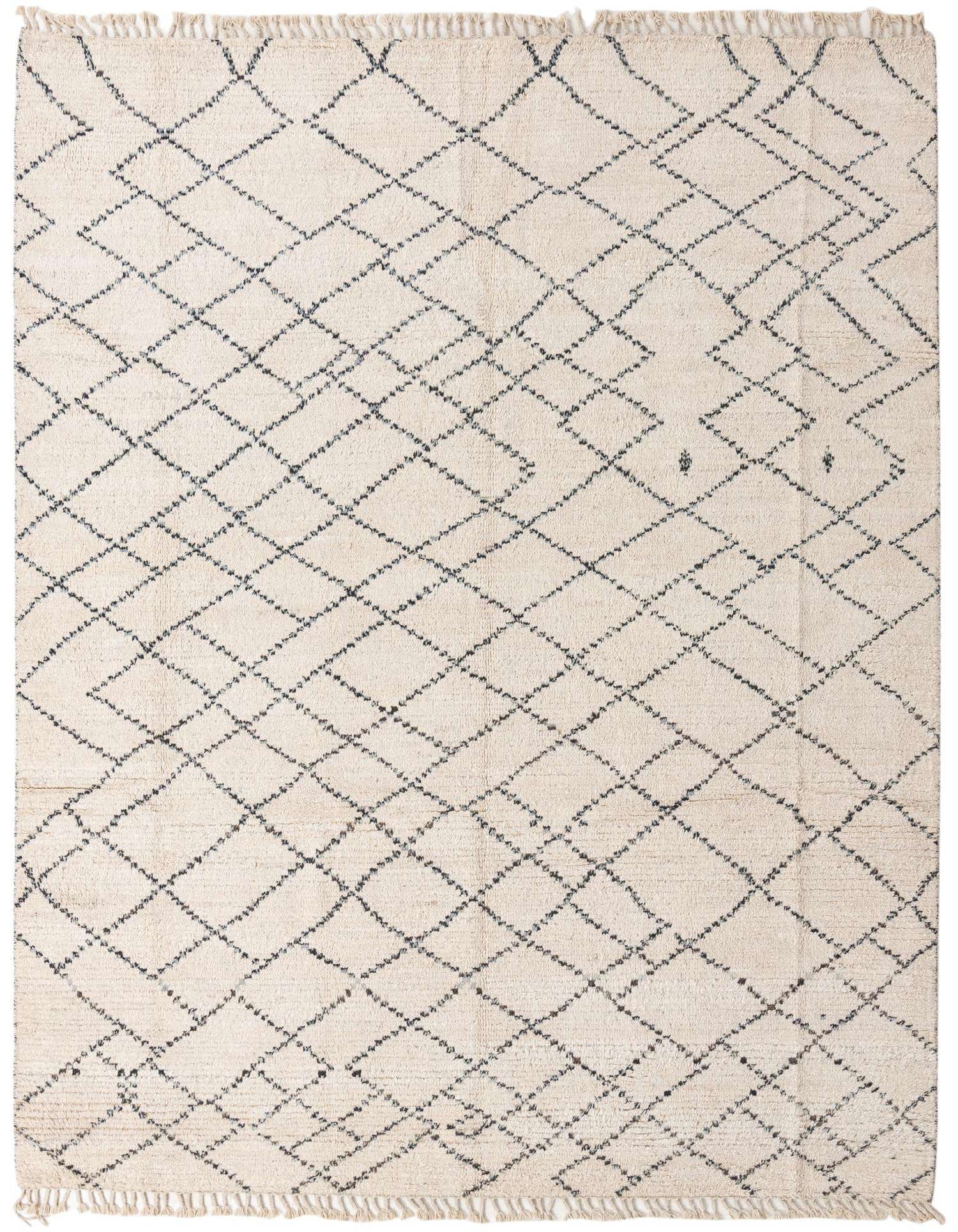 An 8x10 rectangular ivory shag rug with a black tribal diamond pattern and fringed edges.