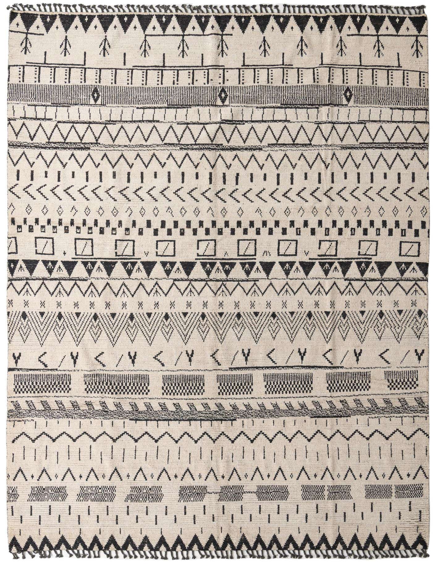 A 10x14 rectangular ivory wool shag rug with a modern tribal pattern in black, featuring various geometric shapes and lines.