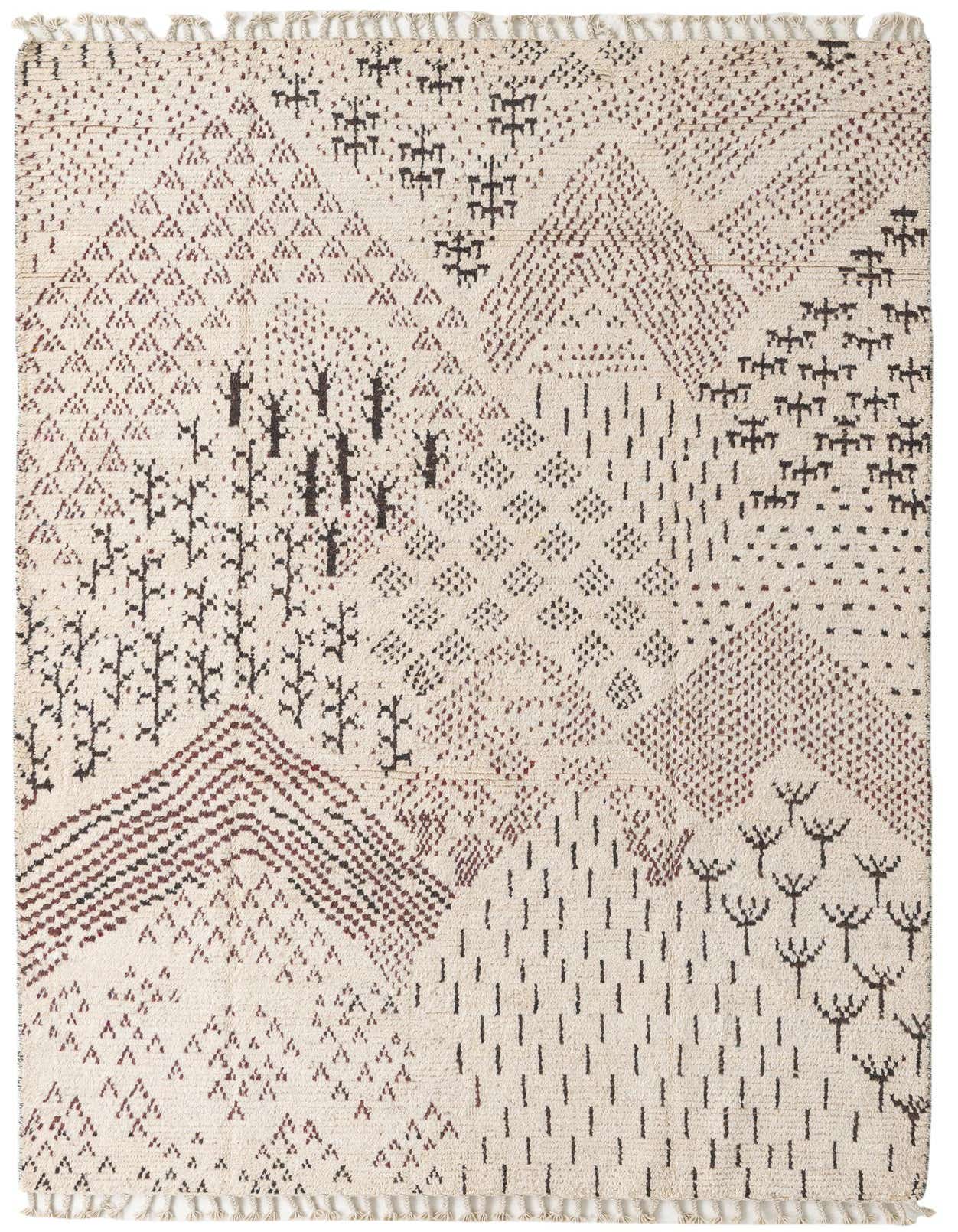 A 6x9 rectangular ivory wool shag rug with a modern tribal abstract pattern in dark brown and cream, featuring geometric shapes and scattered motifs.