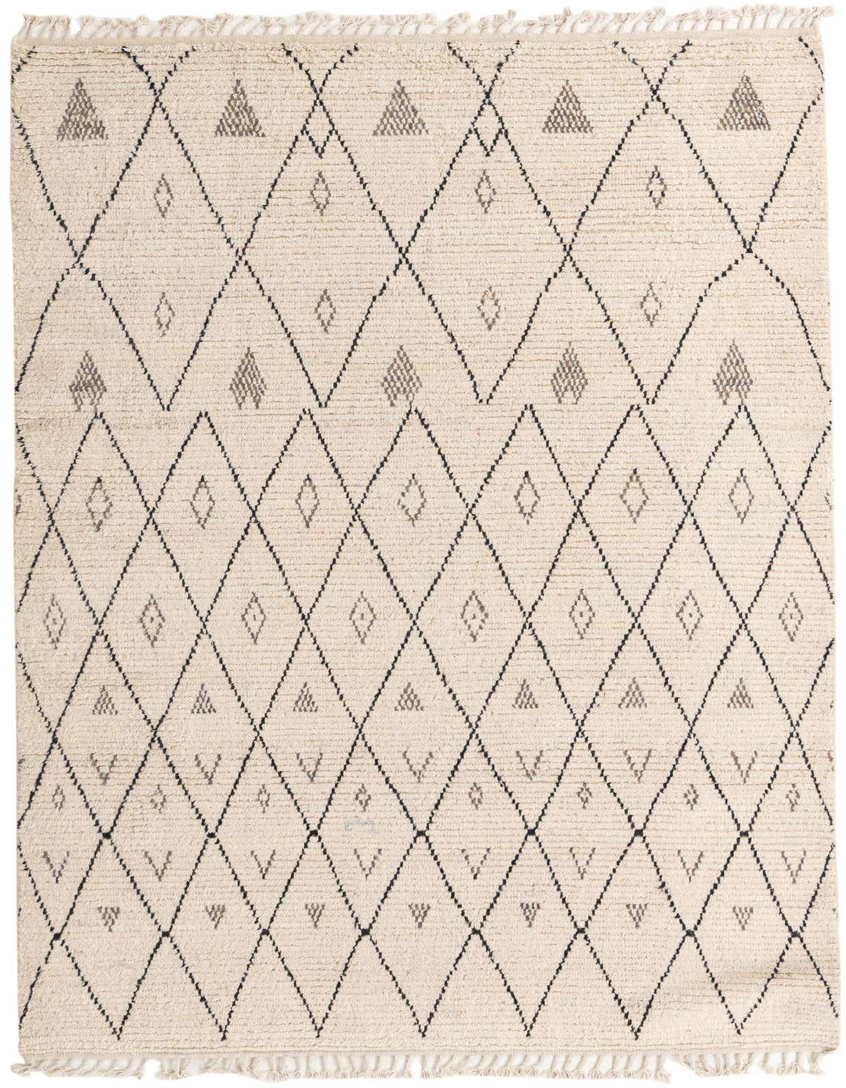 A 6x9 rectangular ivory shag rug featuring a modern tribal diamond and triangle pattern in black and gray.