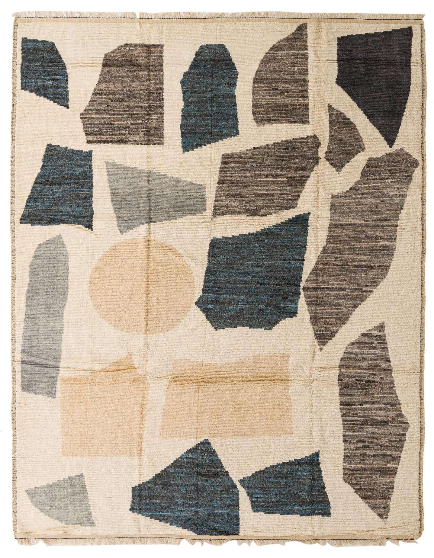 A 10x13 rectangular ivory shag rug with a modern tribal abstract pattern in shades of blue, brown, and light grey.